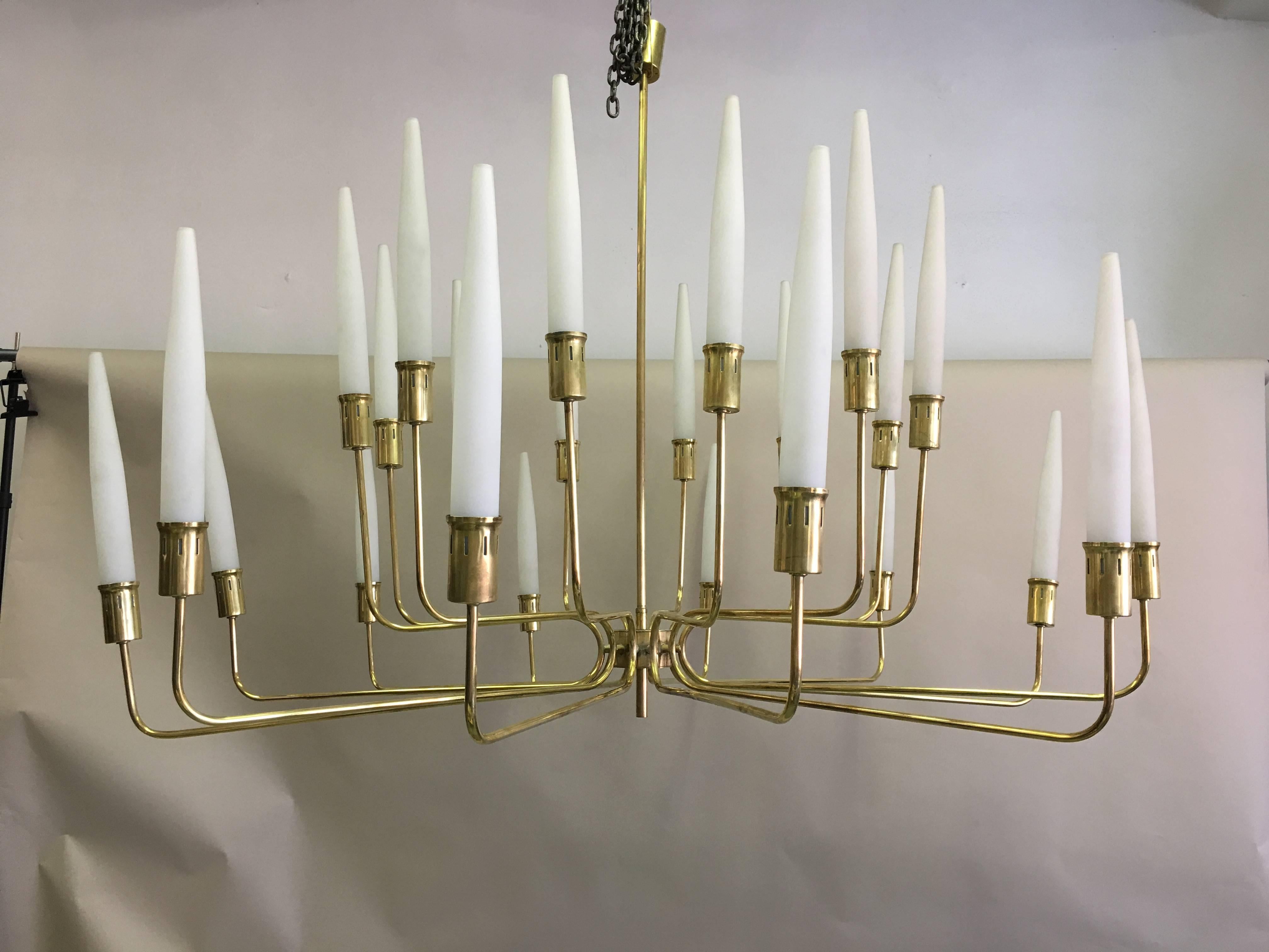A rare and important, large, Italian Mid-Century Modern chandelier / pendant attributed to Fontana Arte circa 1958. The piece features sober, yet dramatic craftsmanship and design. This elegant light features a solid brass frame and 24 satin milk