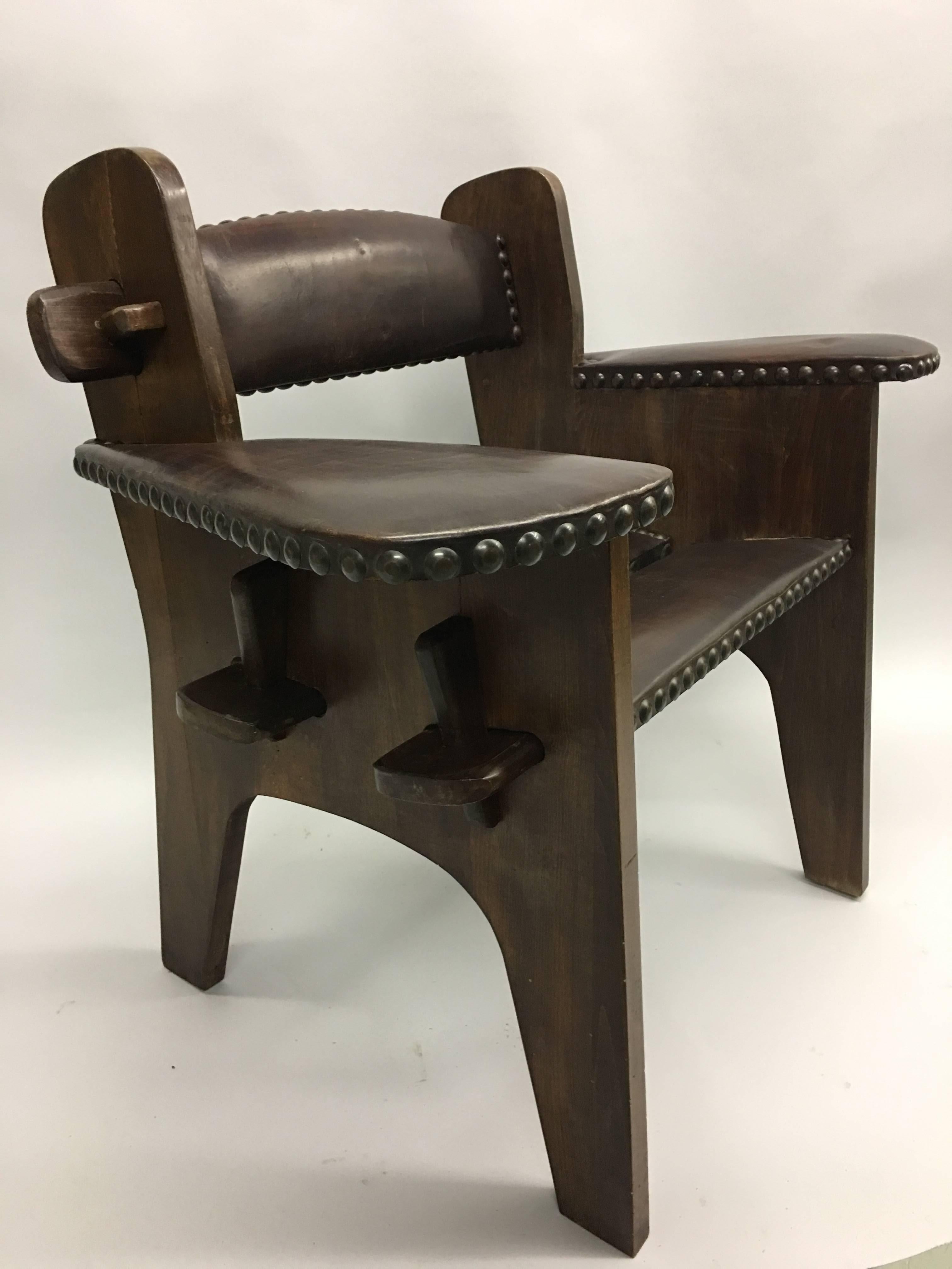 Rare, unique pair of Italian early modernist armchairs attributed to Giacomo Balla. The chairs integrate futurist aesthetics with Arts & Crafts style.

The pieces utilize typical Arts & Crafts materials. They are in solid wood with large studded