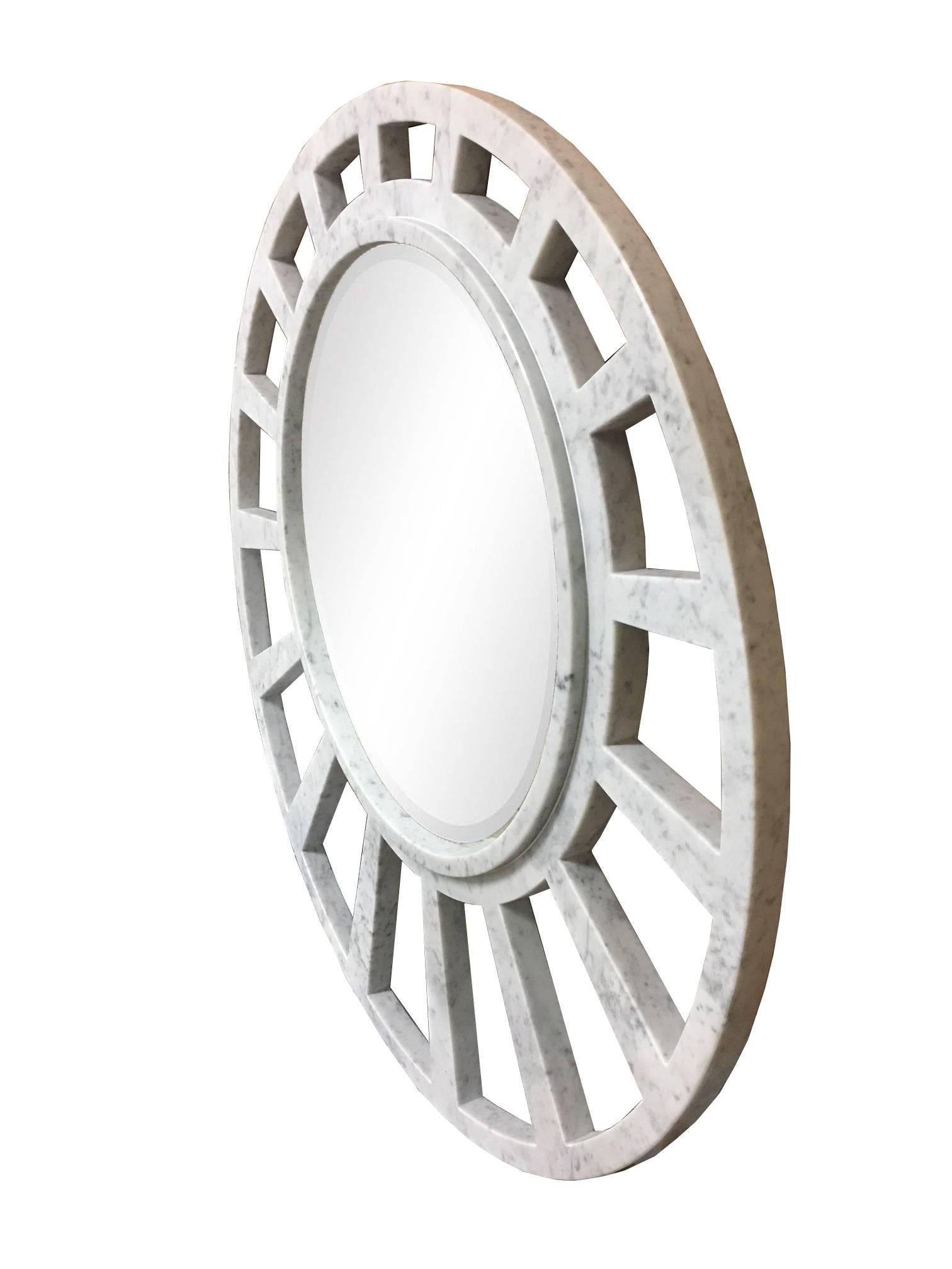 Italian white Carrara marble mirror in handcrafted construction with open geometric pattern appearing elliptical which frames a large mirror. The open framework pattern simulates a sober, modern sunburst form.

Custom sizes are available.