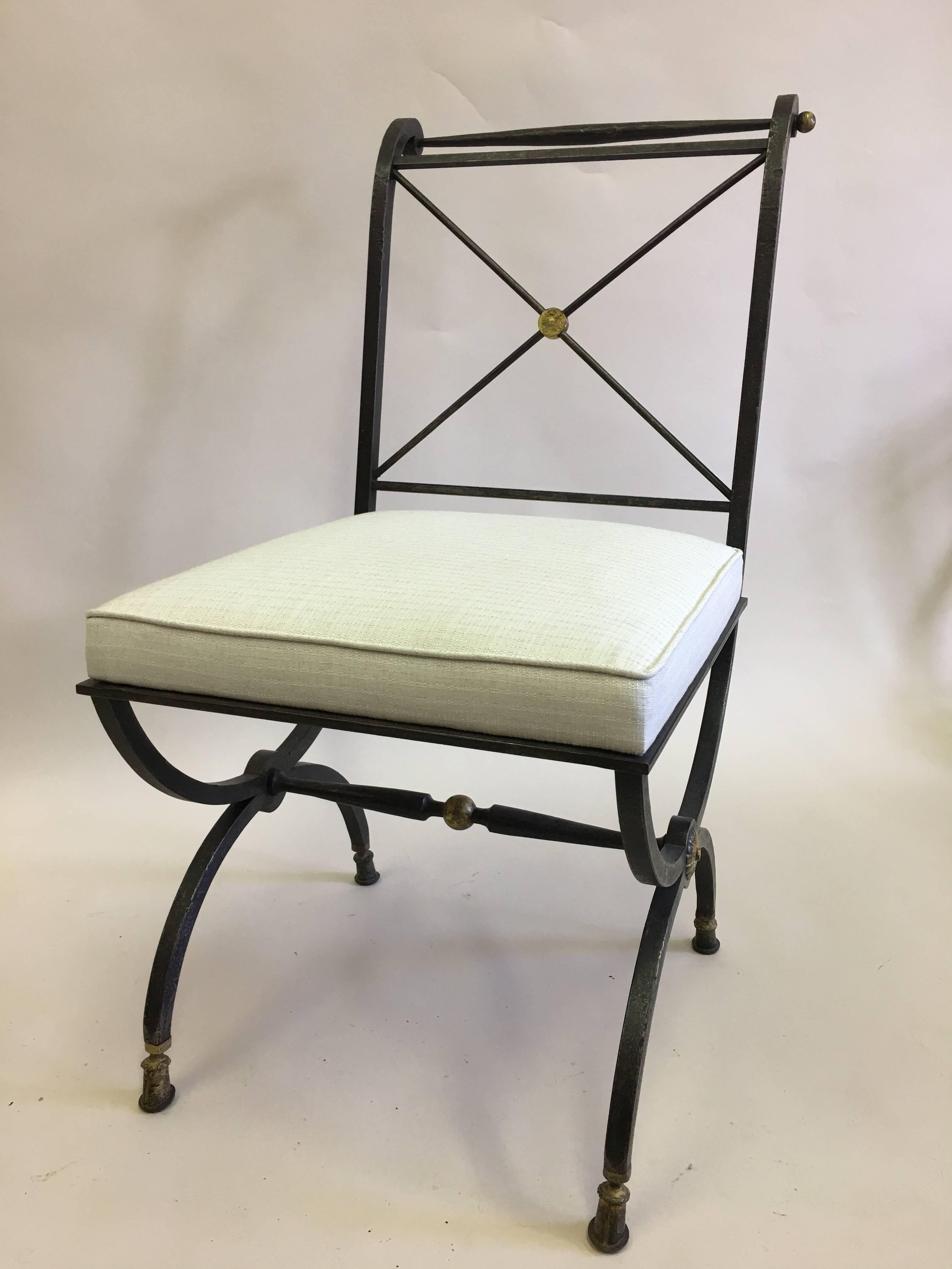 Elegant French Mid-Century Modern Neoclassical form hand-hammered wrought iron chair for desk, vanity or lounge by Gilbert Poillerat, circa 1940, with the seat structure from a design by Andre Arbus.

The chair features a Classic Curule form