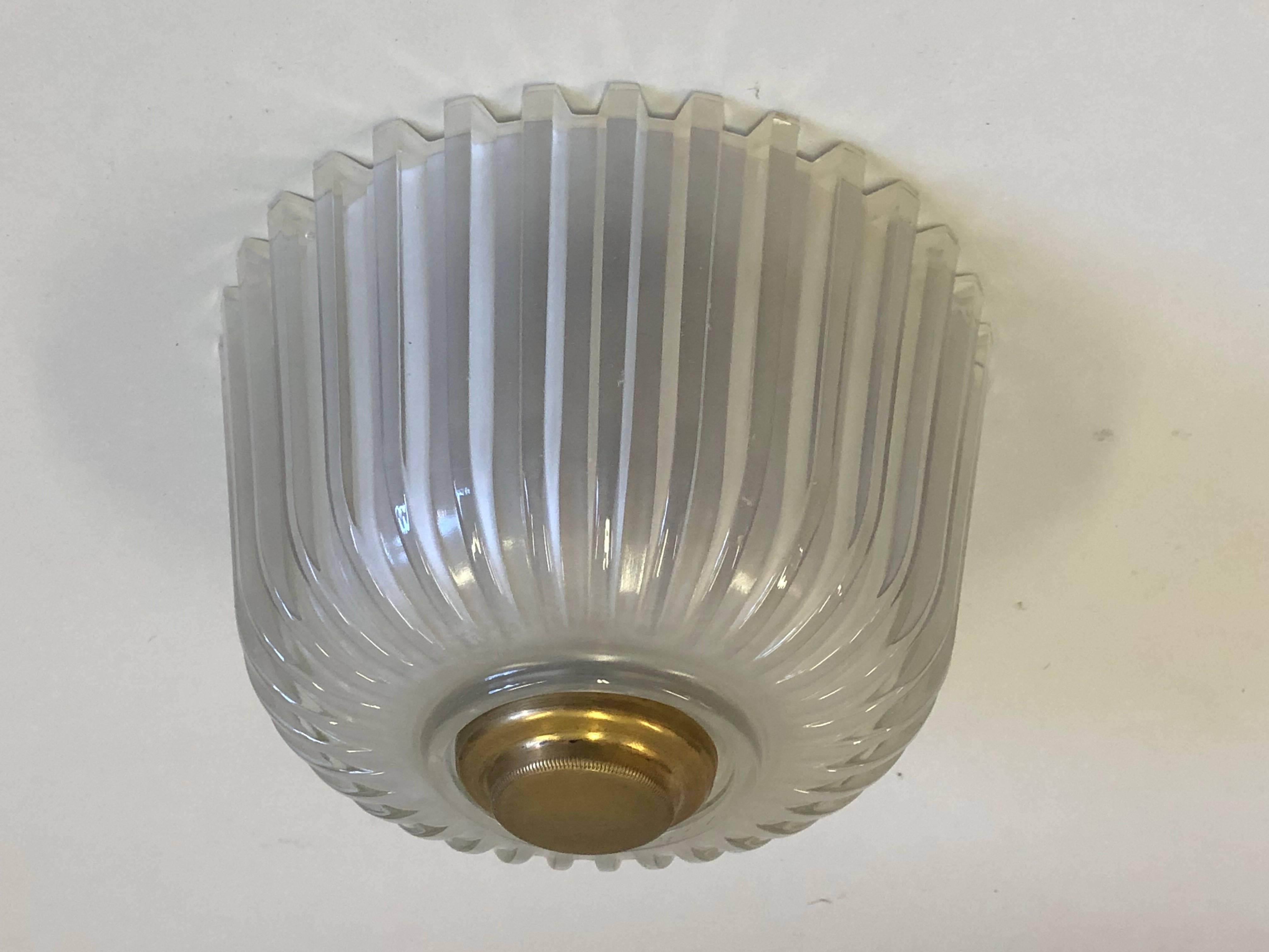 2 Italian Mid-Century Modern Mold Blown Glass Flush Mount Ceiling Fixtures by Seguso. The pieces have Alternating Bands of Frosted and Clear Glass Set in a Ripple Pattern. Brass central disc caps complete the pieces.

Sold as a pair.