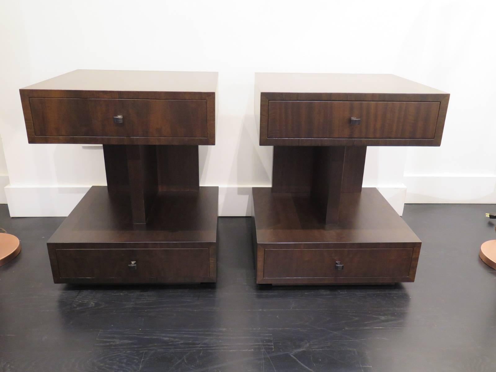 Beautiful mahogany sidetables by Andrew Szoeke with top and bottom brass handled drawers. Refinished, with brass handles. The side tables have fully finished backs.