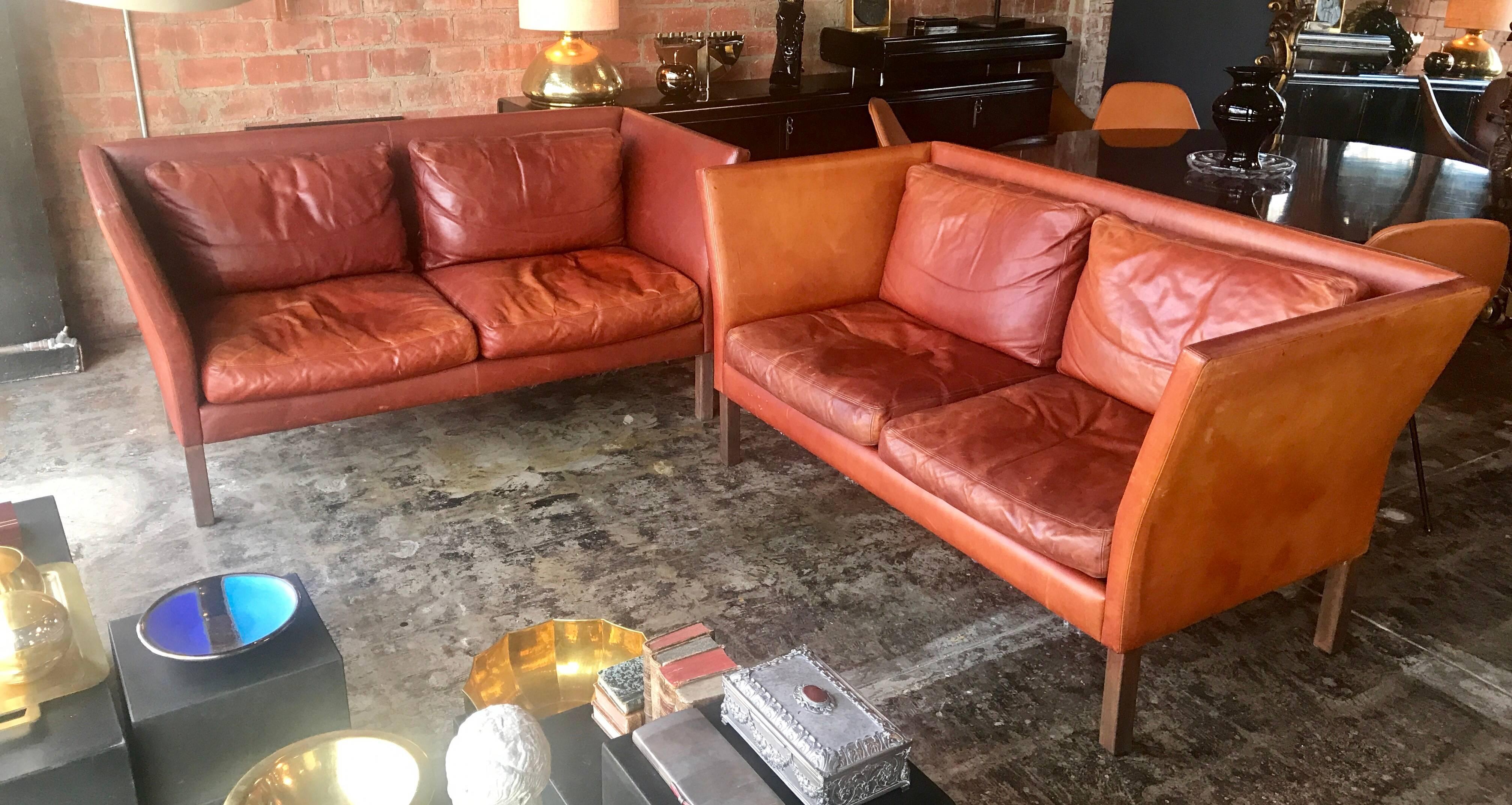 Pair of beautiful cognac leather sofa by Mogens Hansen with stained beech legs.