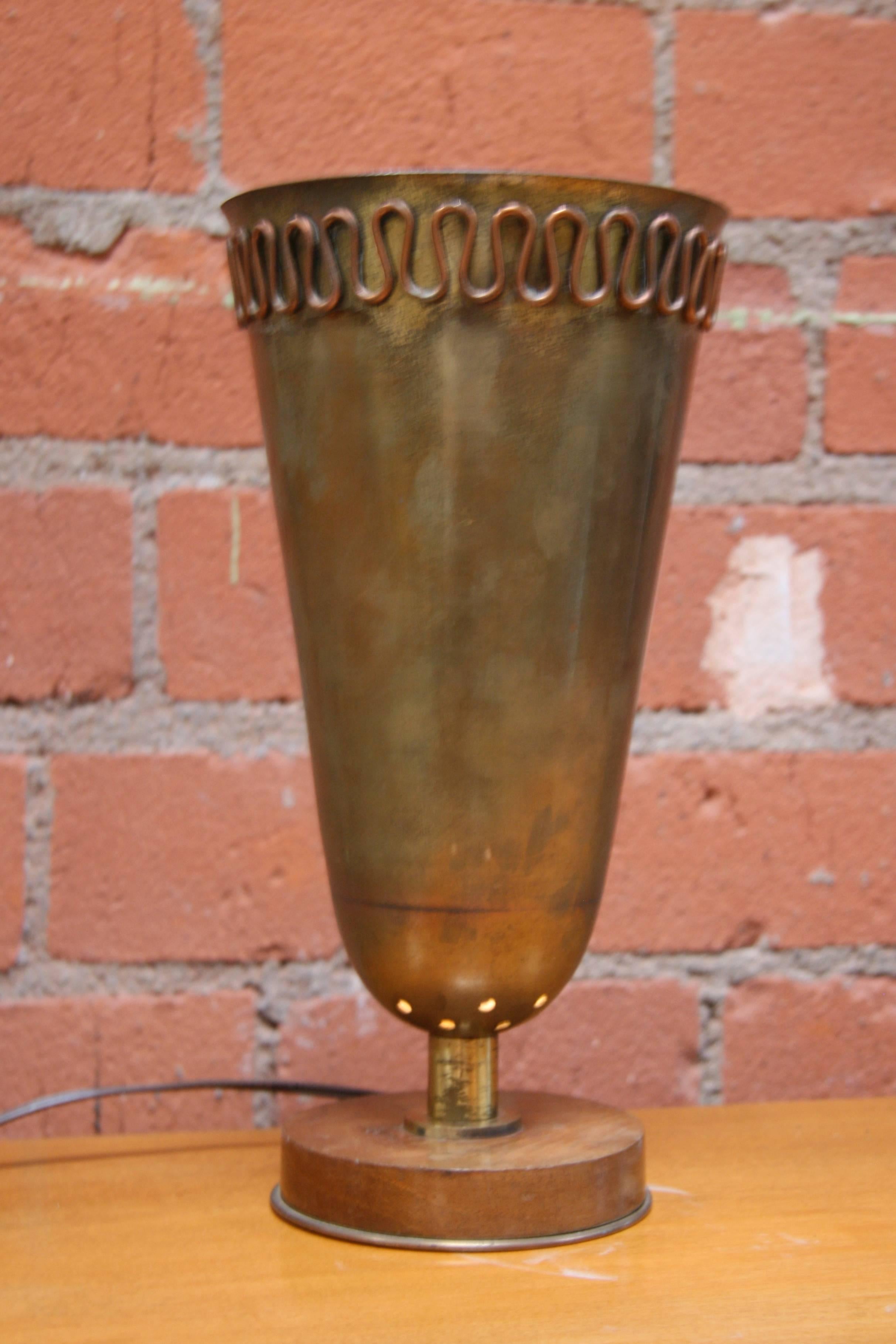 A vessel of light with a Grecian looking design.