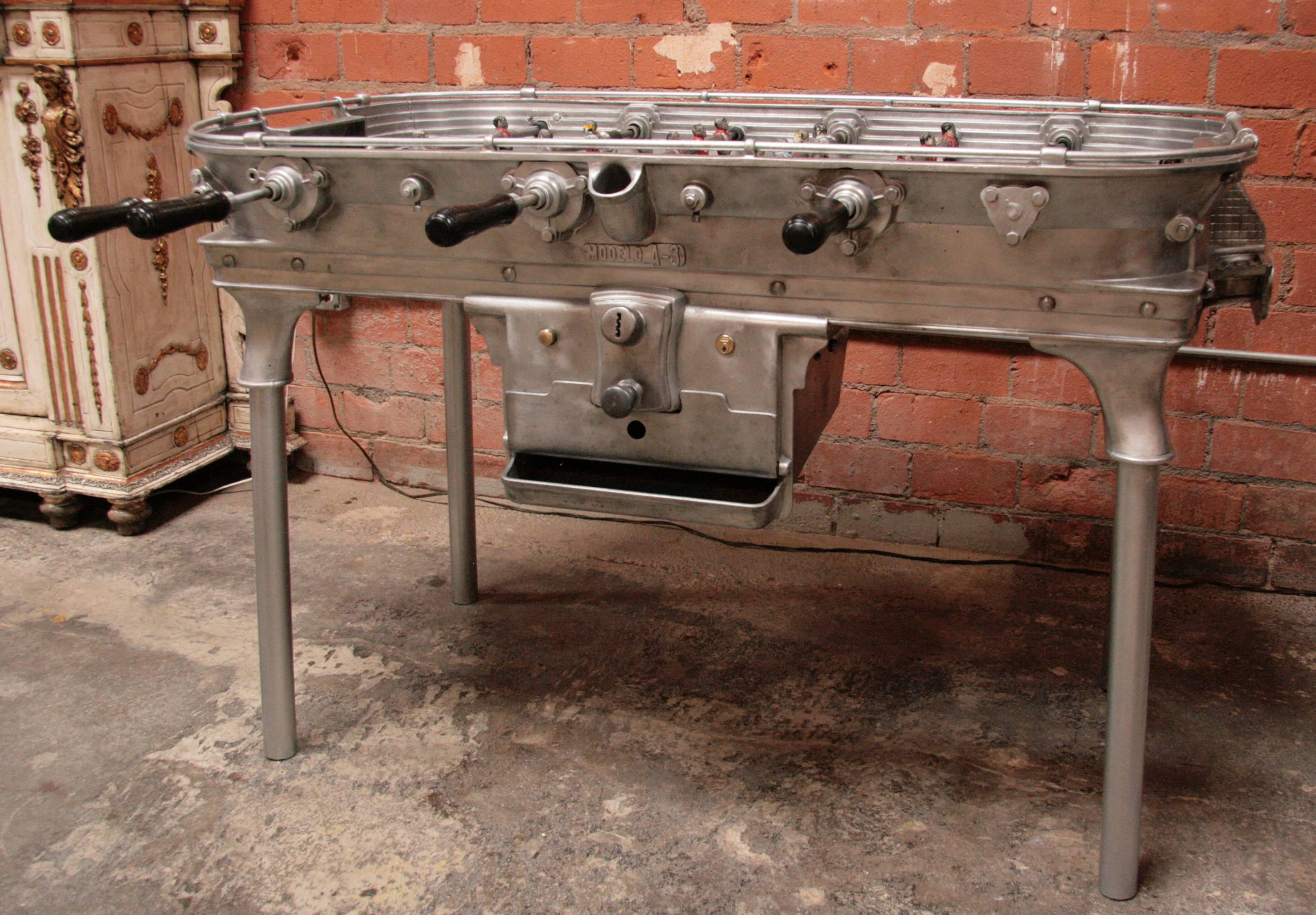 Vintage cast metal foosball table having stadium form with cast players all supported on iron legs, circa 1930.