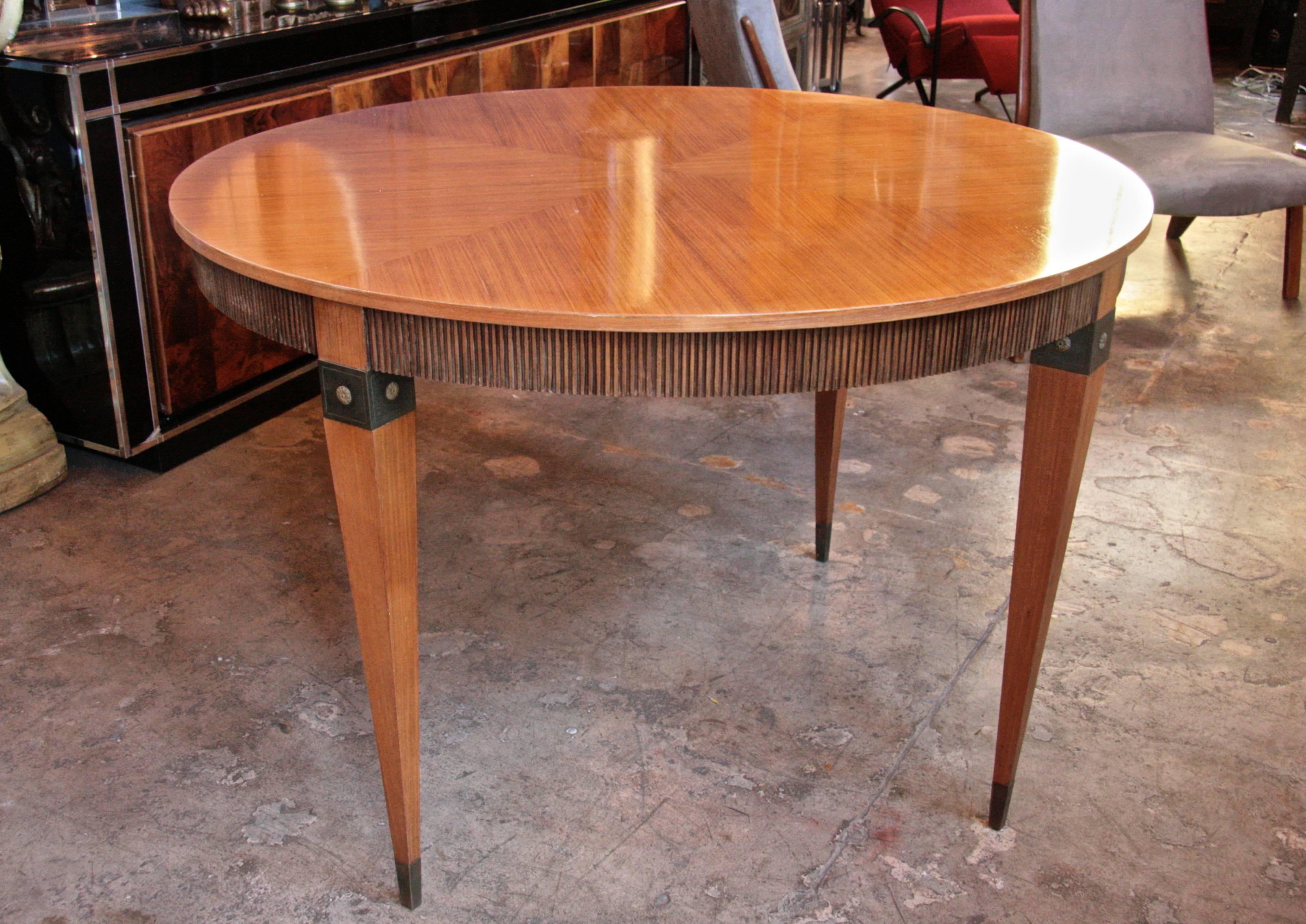 Italian round dining table with bronze inserts.