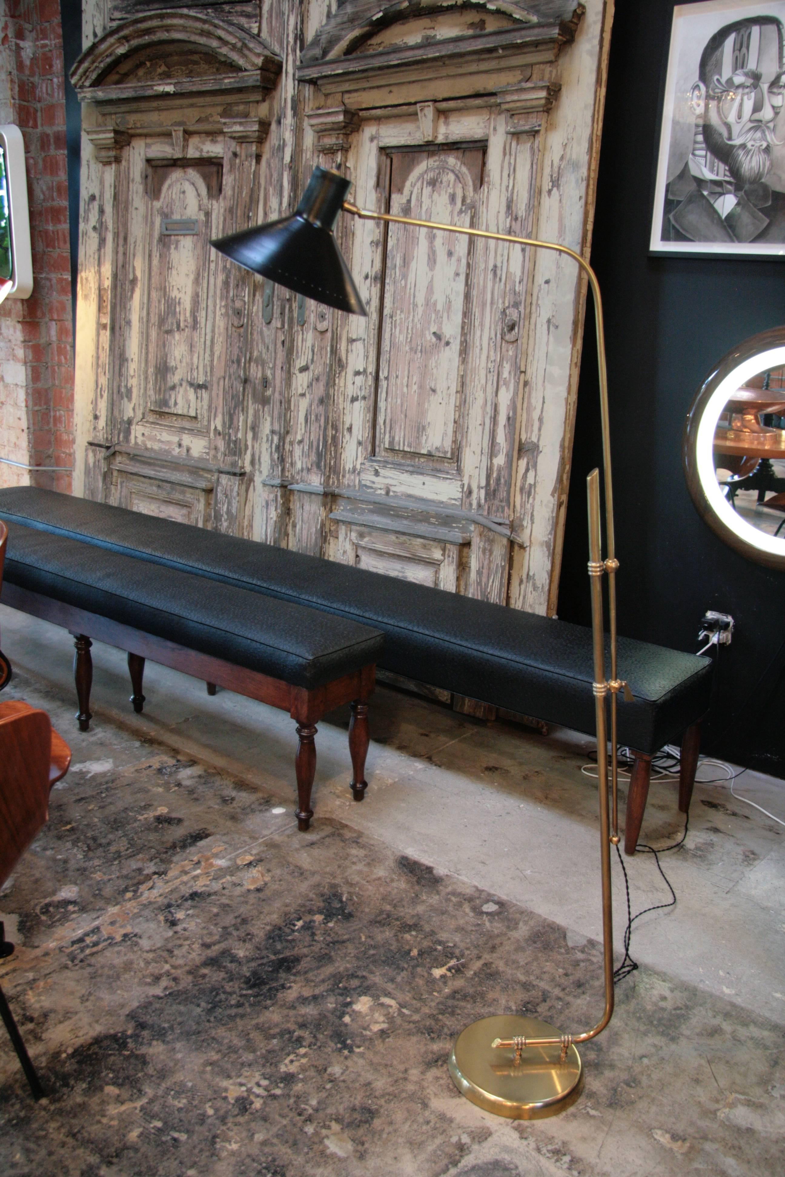 Italian 1960 floor lamp with brass base and black lacquered shade.
Adds style to any room.