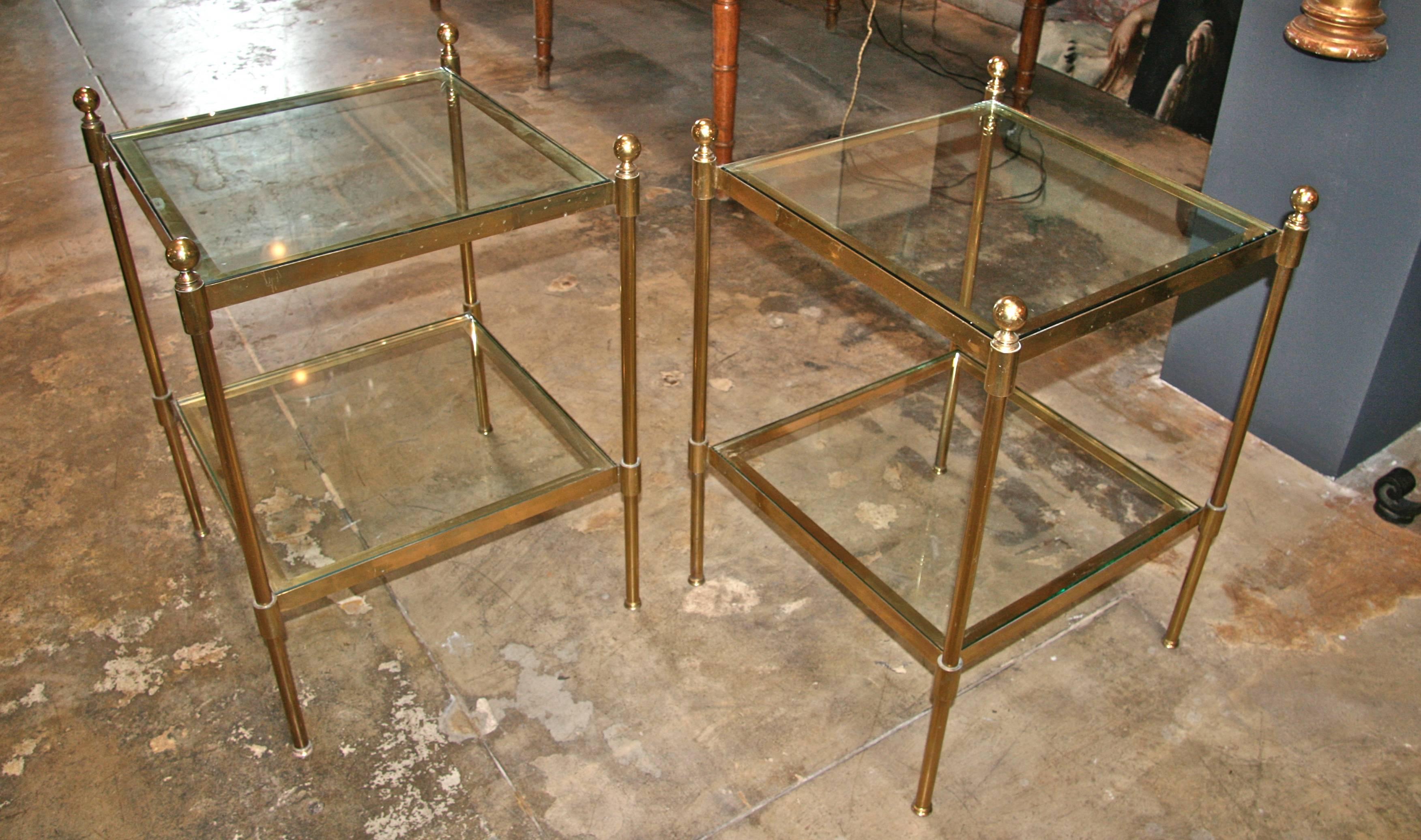 Pair of Italian 1960s two-tier end tables in brass and glass.
