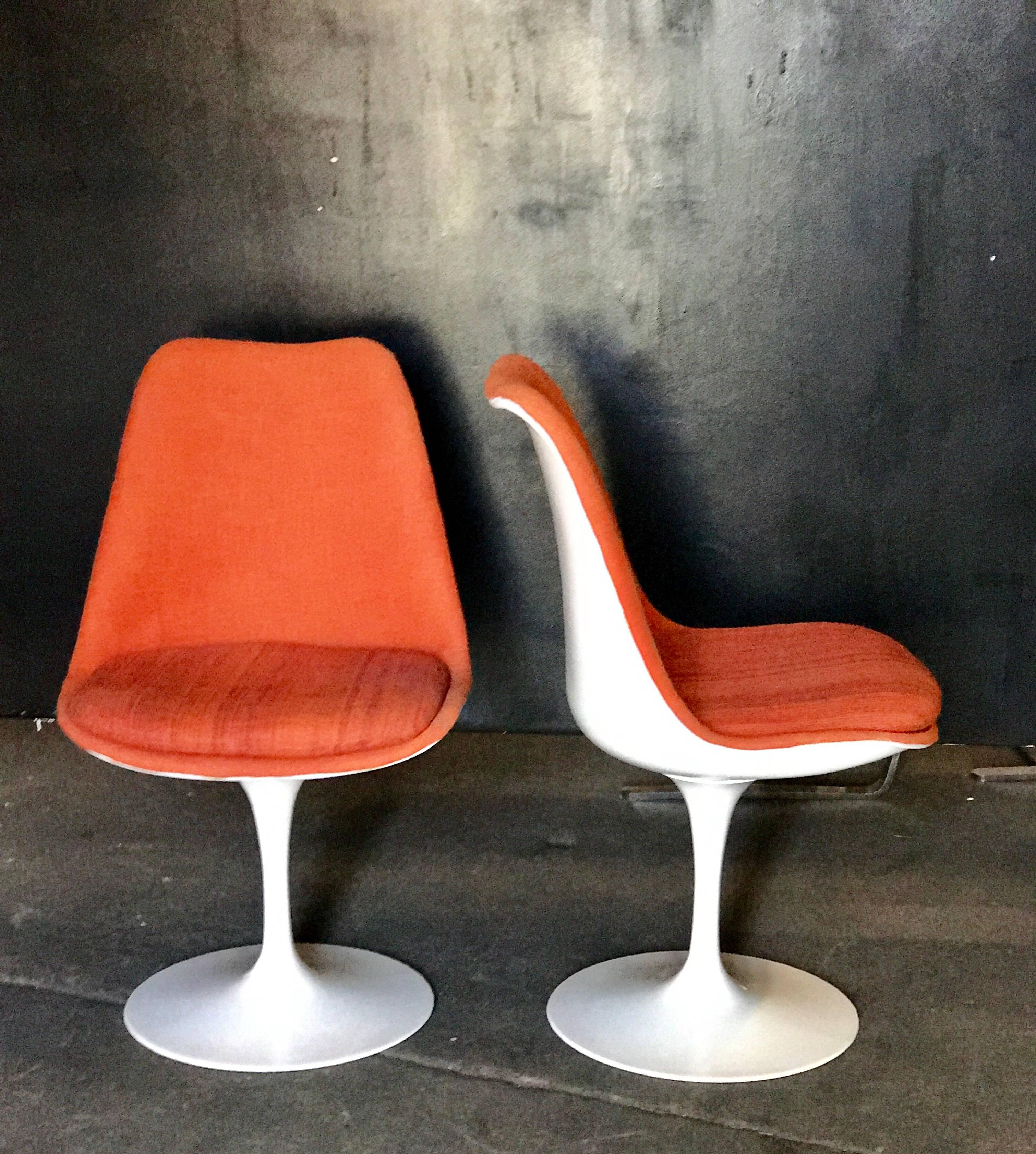 Pair of Saarinen swiveling orange side chairs. Now take a ride on these babies.