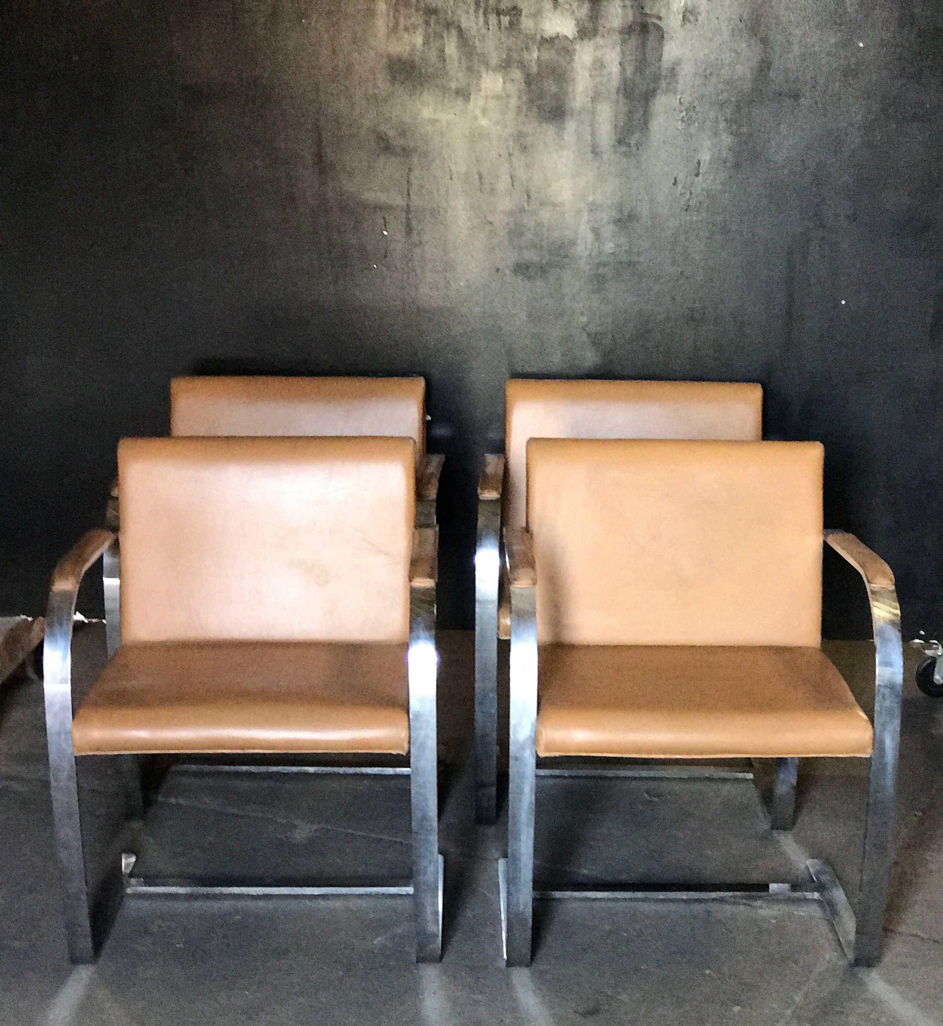 Ludwig Mies van der Rohe's flat bar Brno chair is comprised of polished chrome-plated steel and leather, made circa 1960s by Knoll. These chairs retain their original light brown leather upholstery.