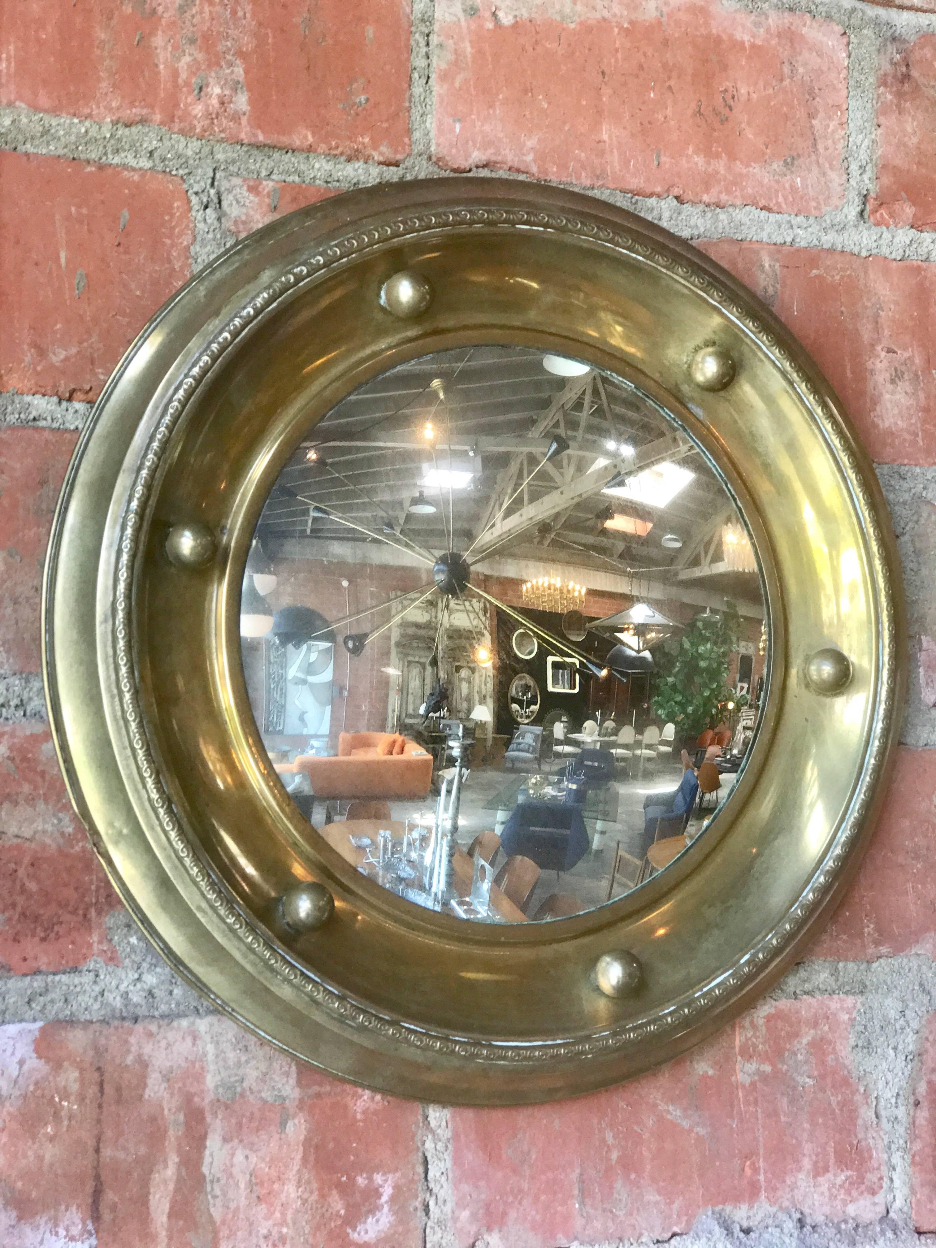 Antique brass round wall mirror.