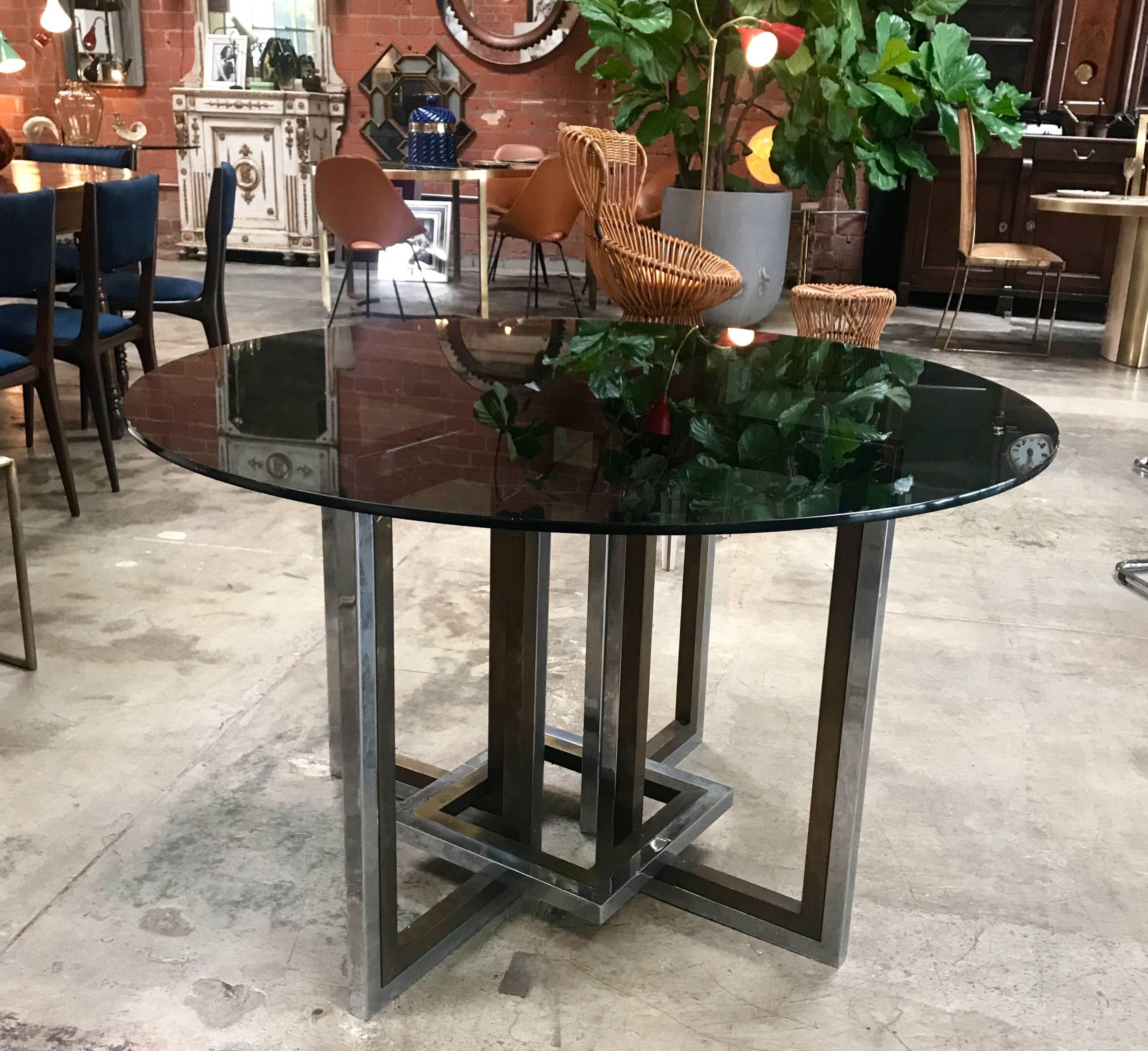 Romeo Rega, chrome, brass and tinted glass dining room table, Italy, 1970
The glass above can be changed with one bigger or with one square, the base is really strong.