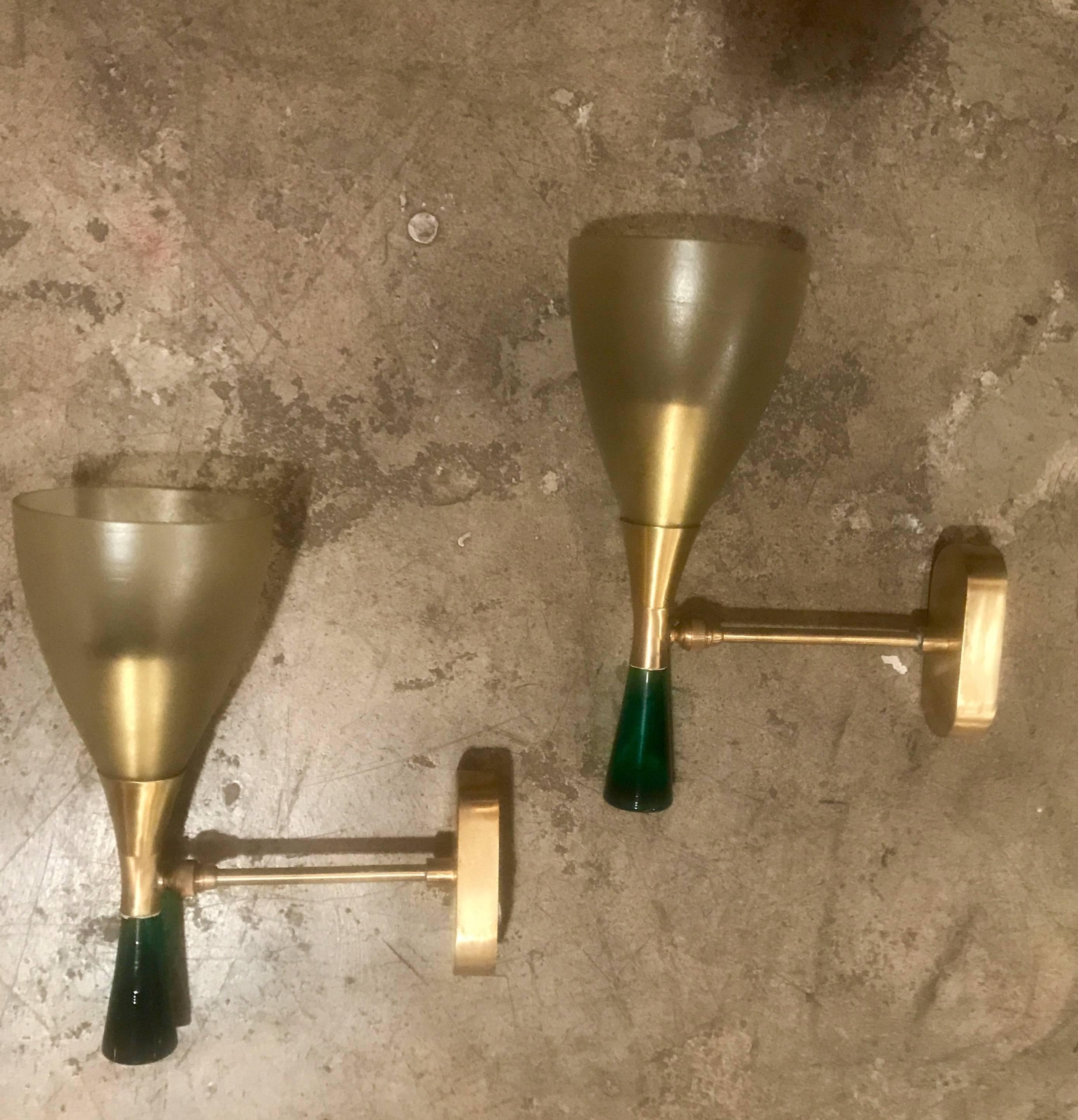 Sconces in brass with satin glass cone and more solid green glass on the base.