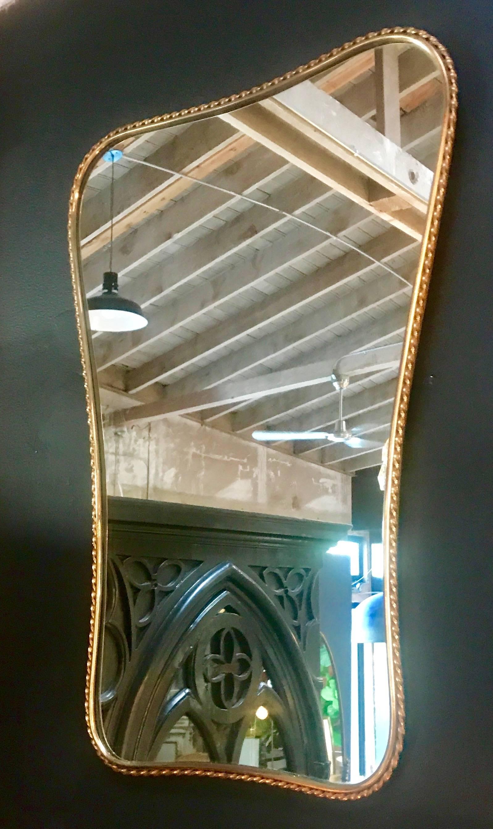 Italian mirror 1960s with worked brass frame.