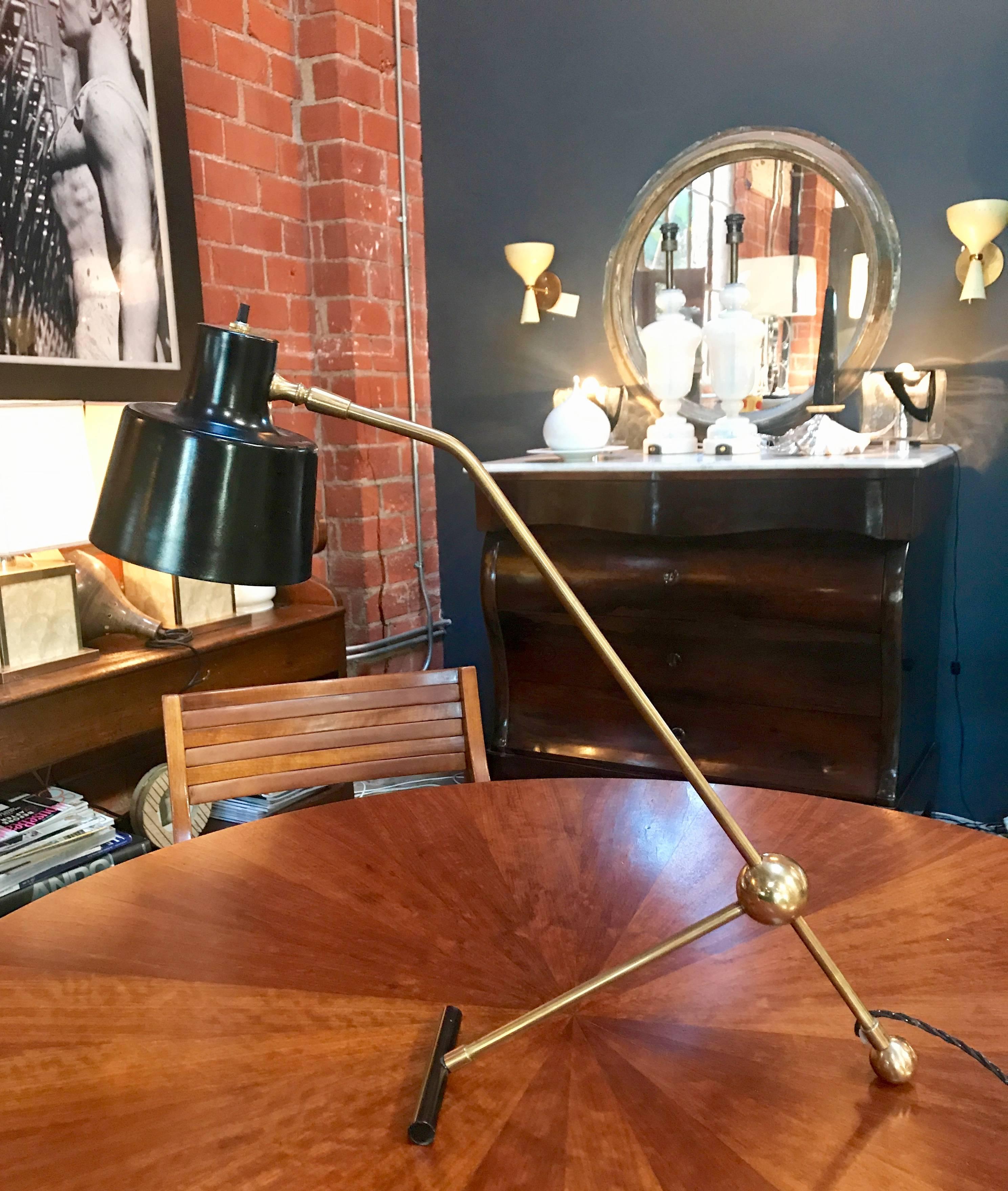 Italian adjustable table lamp in brass and metal.