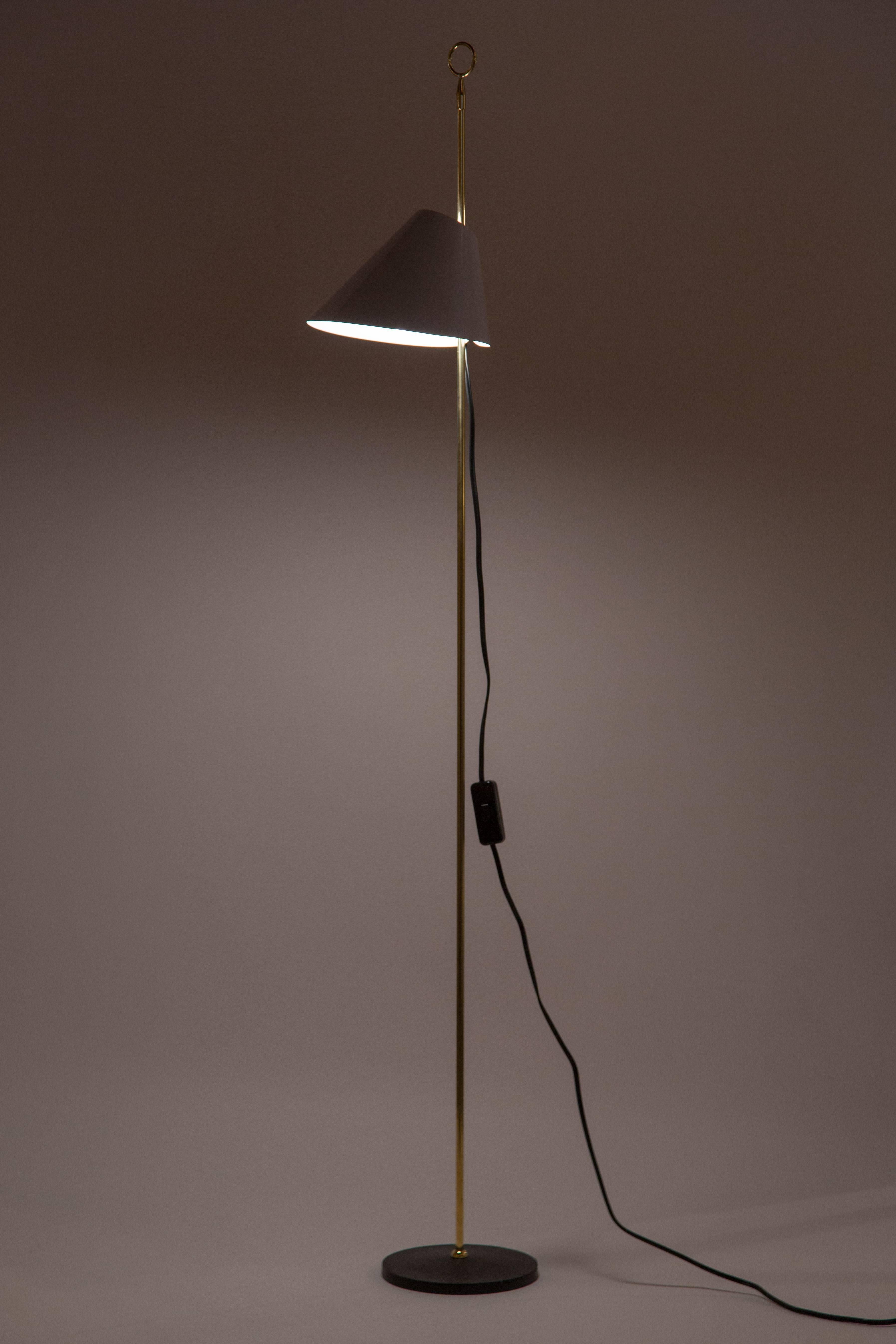 Floor lamp, with black painted cast iron base, stem in natural brass, height of shade is adjusted by sliding reflector in Azucena white. E27 halogen 60w maximum bulb.