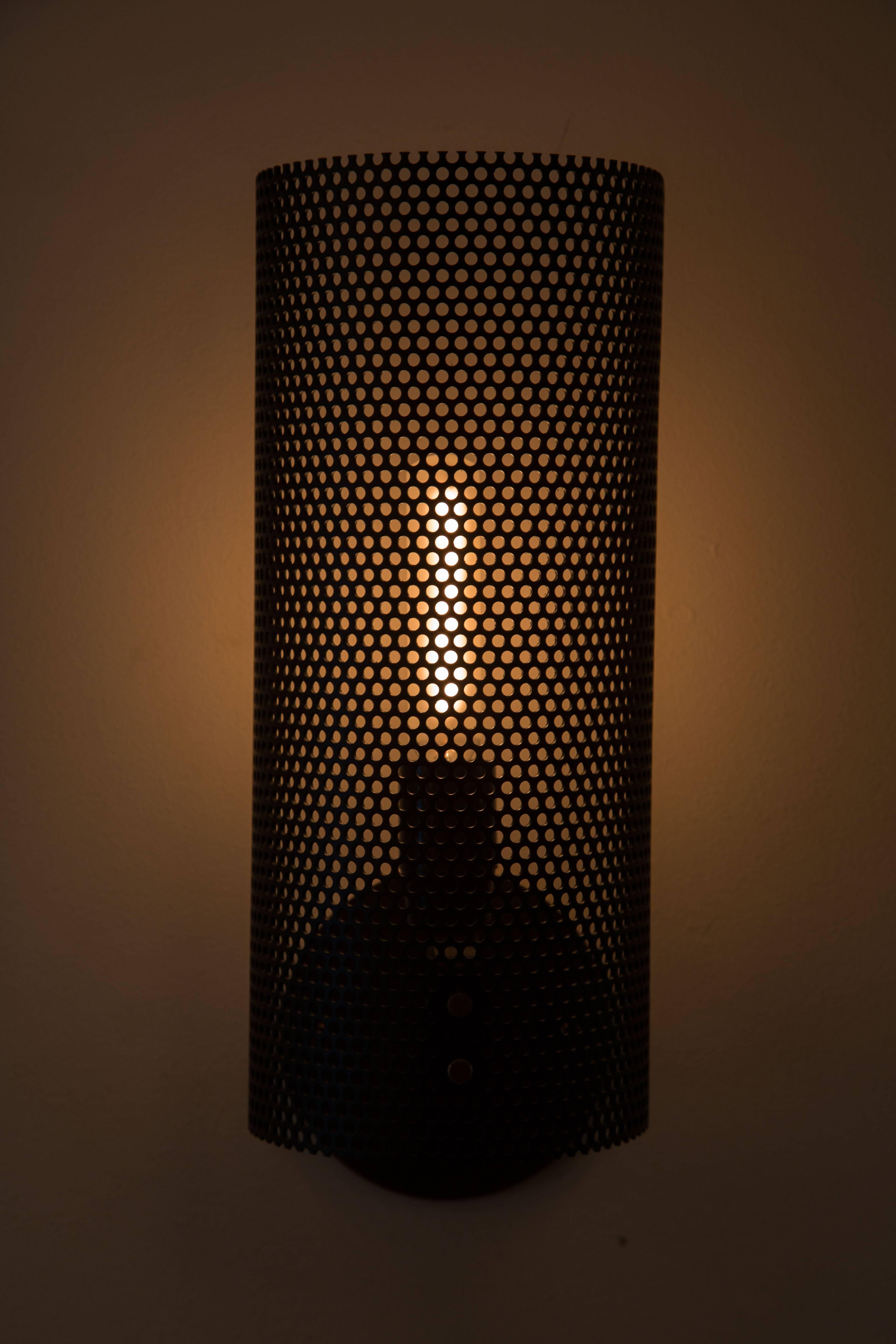 Rewire Custom Perforated Sconce. Sconces can be powder coated in various colors. Requires one E26 60w maximum bulb. Priced and sold individually.