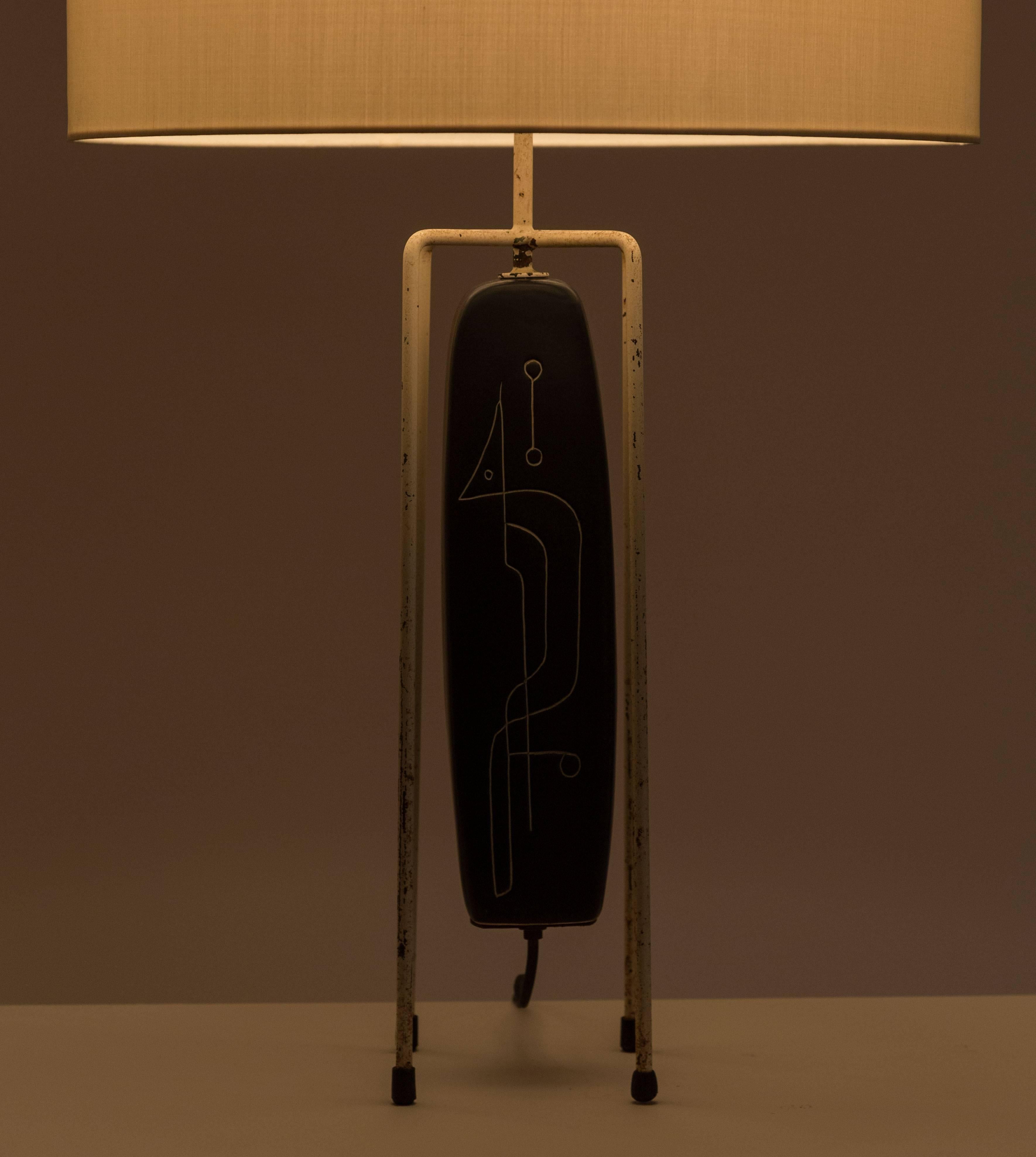 American iron and cast porcelain table lamp. Abstract design hand-carved on to the porcelain base. Original cord. E26 75w maximum bulb. Shade not included but can be custom fabricated. Contact us for details.