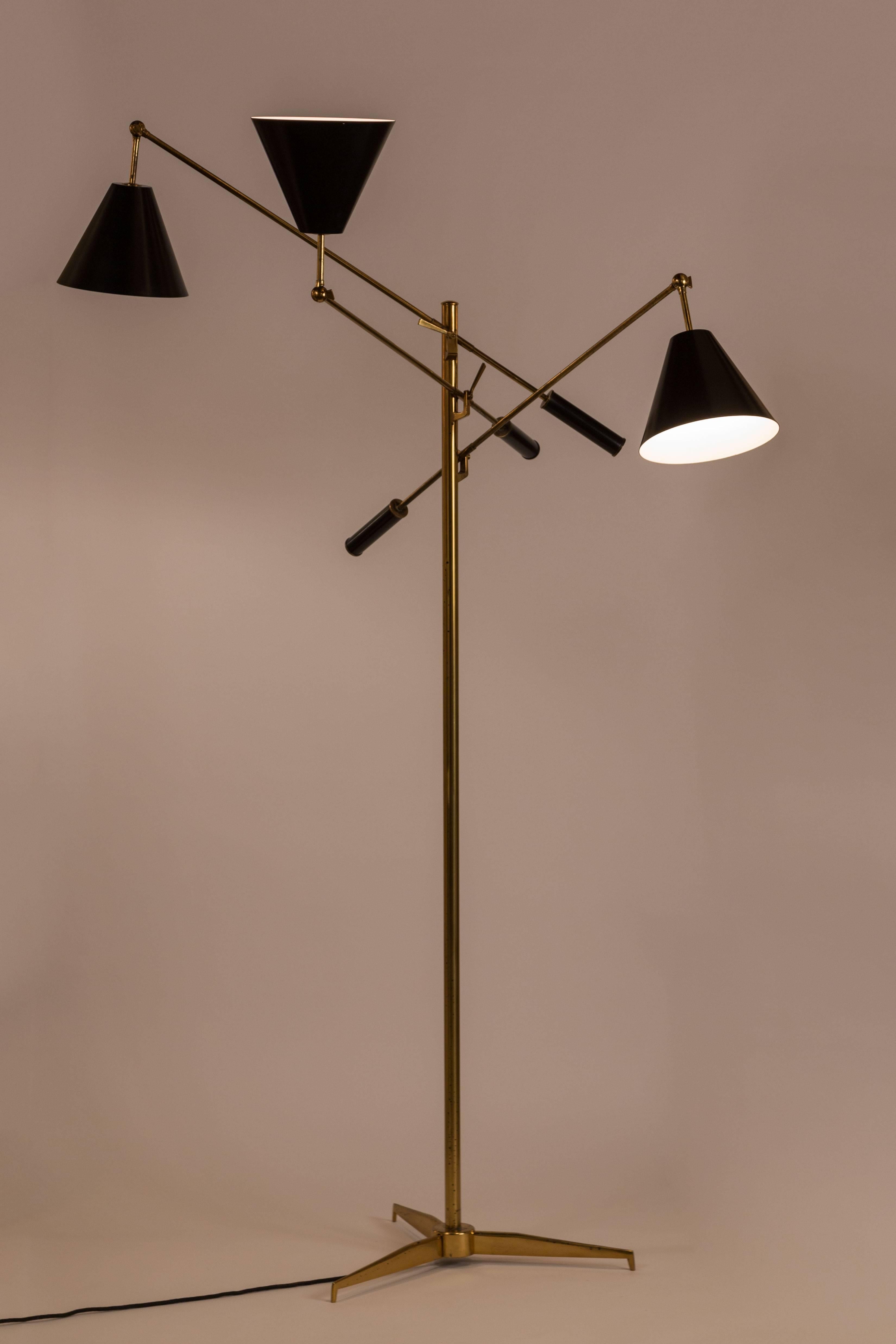 Rare three counter balance arm floor lamp with leather grips by Angelo Lelli for Arredoluce. Solid brass. Each shade articulates with brass key. Rewired. Takes 3 E27 60w maximum bulbs. Maintains original manufacturers stamp on brass floor switch.