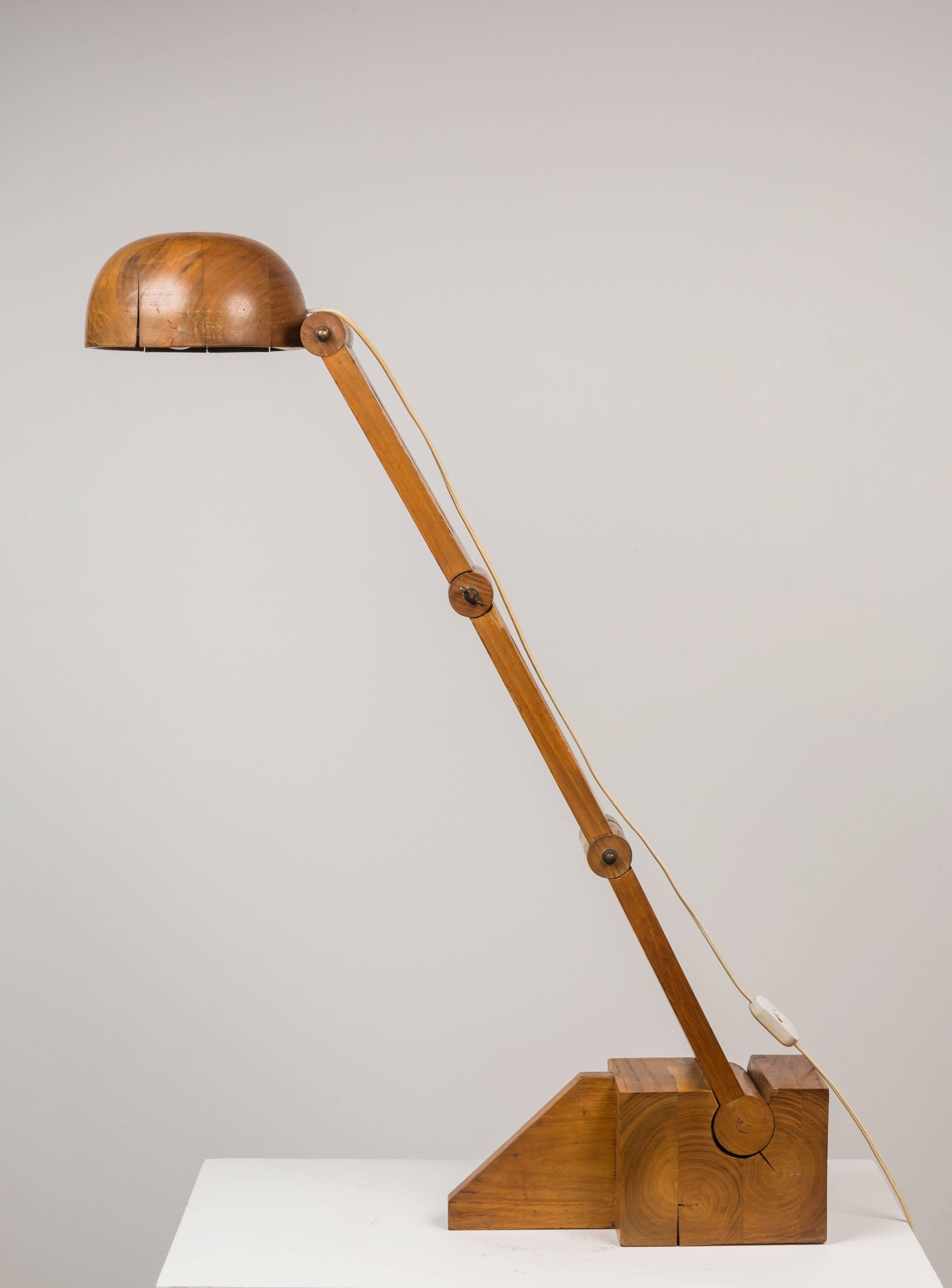 Solid wood table lamp designed in the 1960s by Paolo Pallucco for Pallucco Roma. Arm of lamp moves forwards/backwards and adjust to various positions at the joints. Retains original label. Original wiring. Takes an E27 60w maximum bulb.