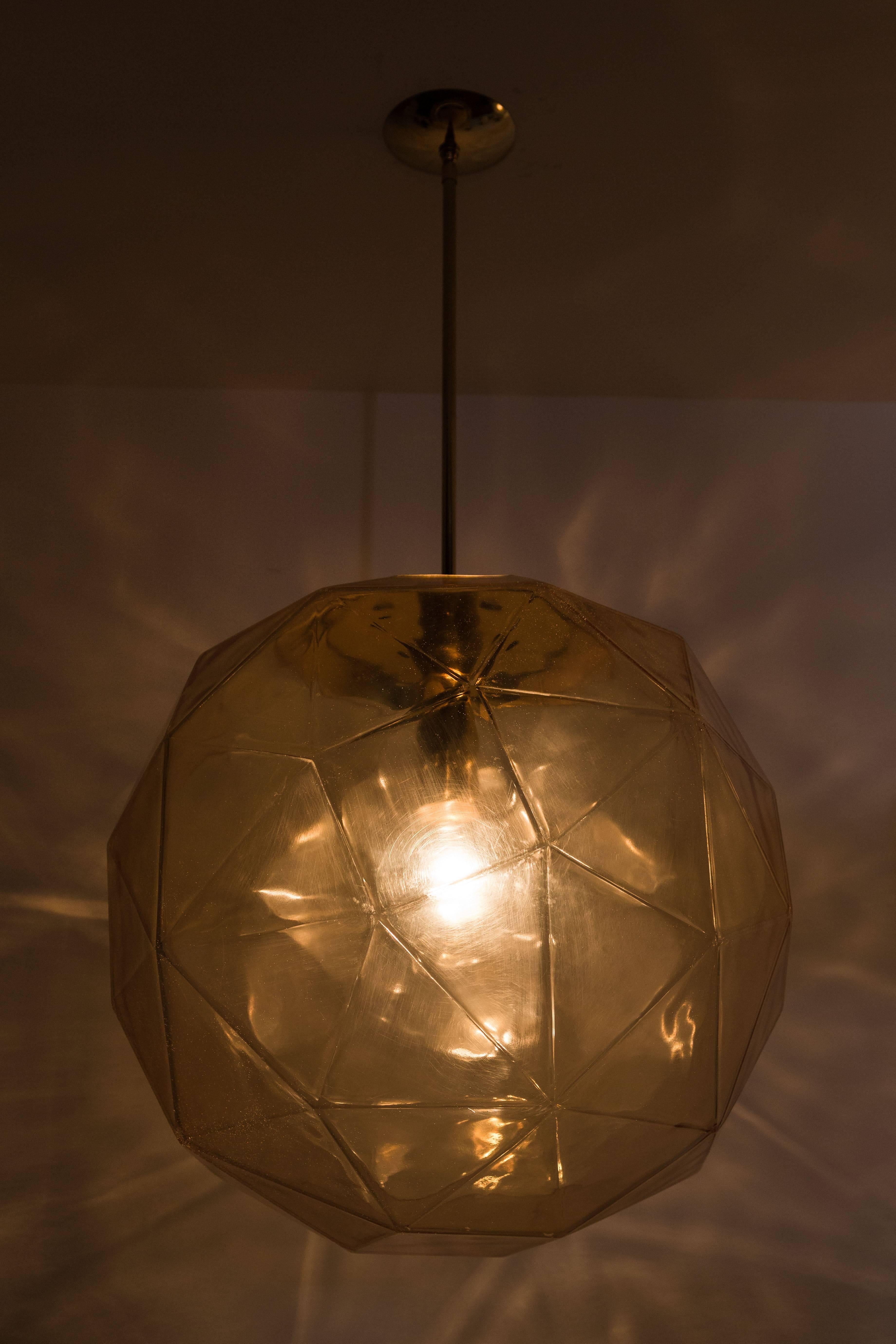 Two large geodesic acrylic globes designed by Habitat. Priced individually at $3600. Rewired. Brass canopies. Overall height can be adjusted. Each globe takes an E26 60w maximum bulb.