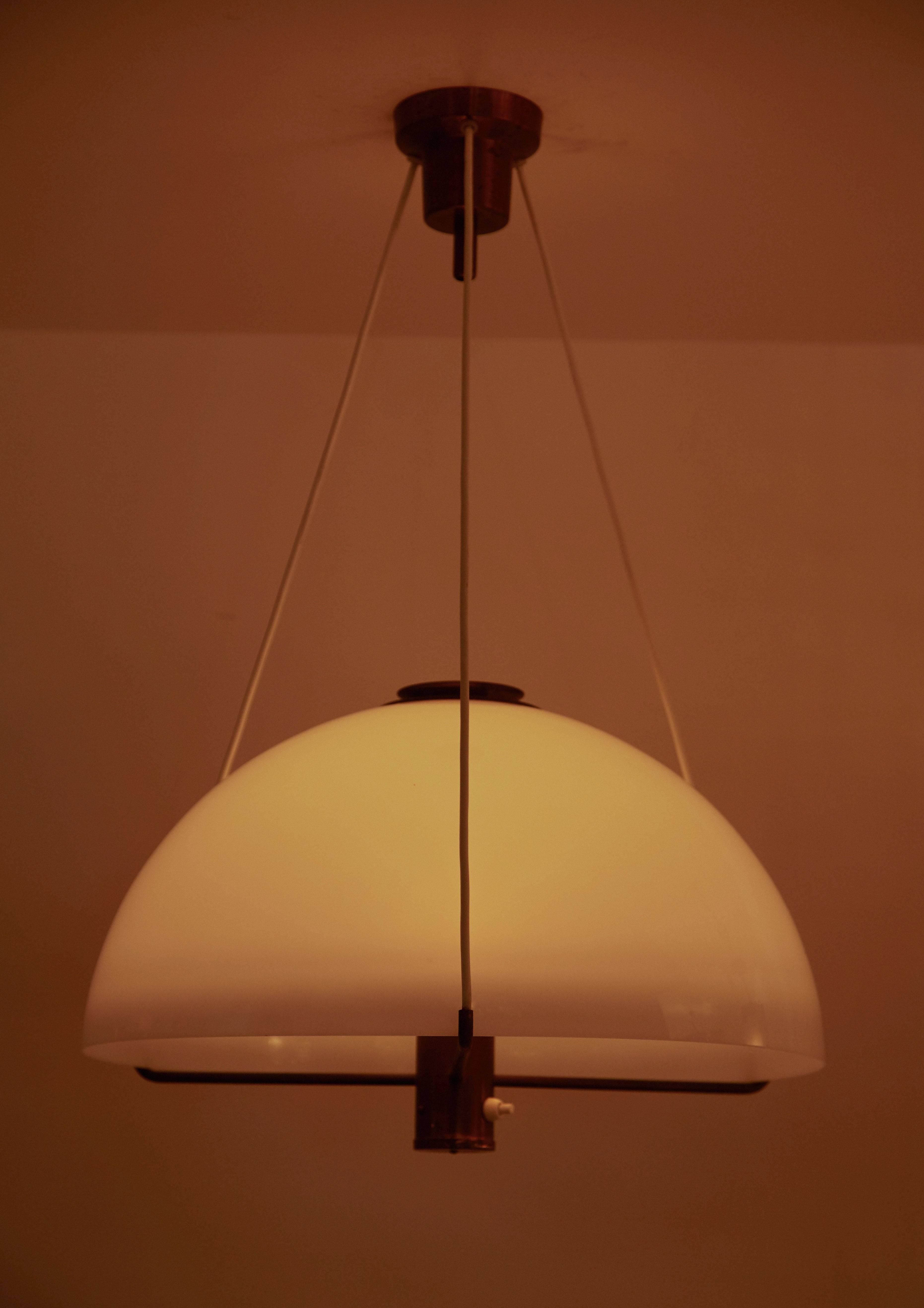 Suspension light by Hans-Agne Jakobsson for Markaryd. Designed in the 1950s. Diffuser in white acrylic and frame in brass. Wired for US junction boxes. Takes an E27 75w maximum bulb.

Fixture dimensions:
Diameter 16.9