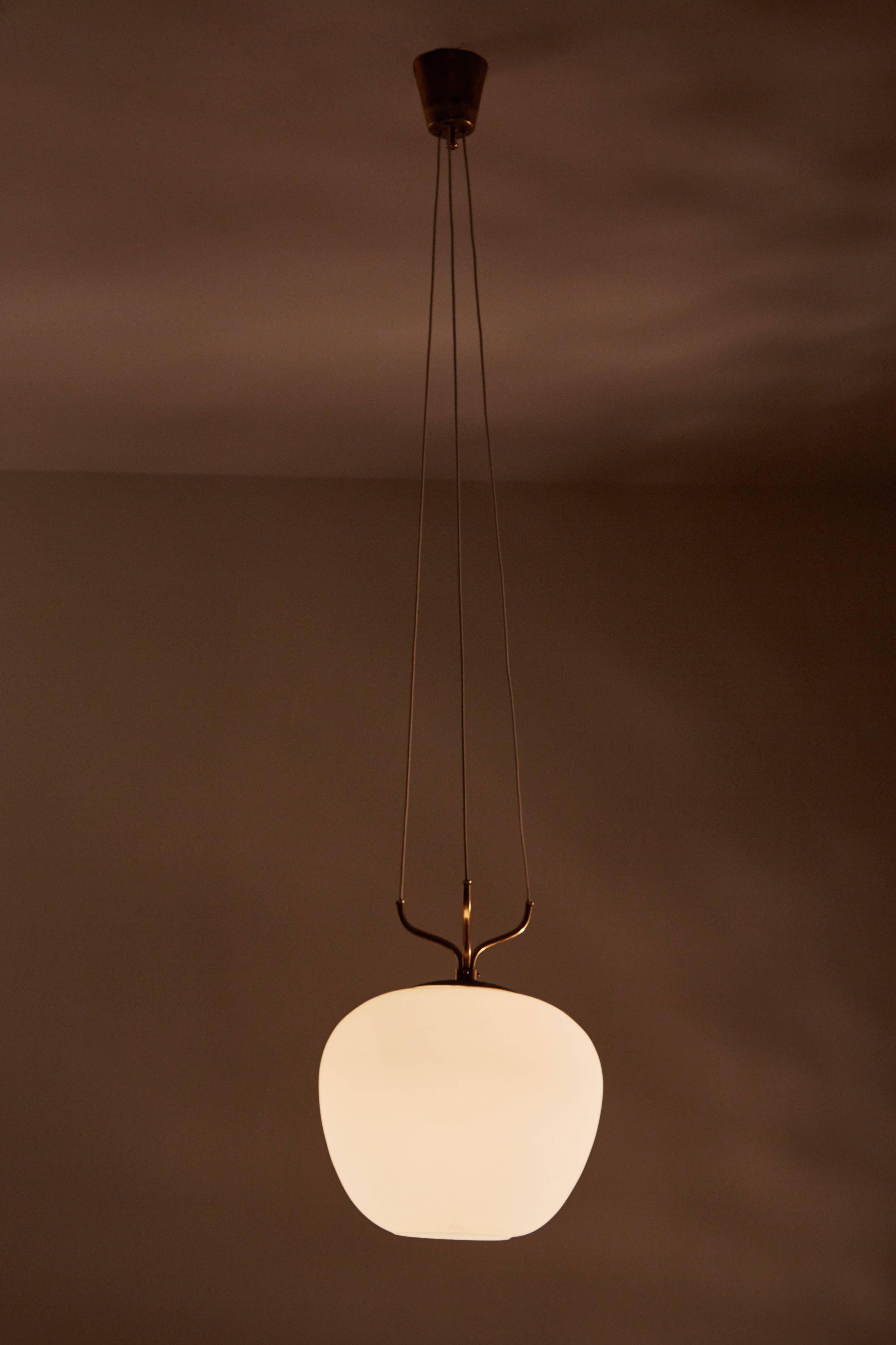 Suspension pendant with satin glass and brass hardware. Designed by Stilnovo in Italy, circa 1950s. Original canopy with custom backplate. Rewired for US junction box. Takes one E27 100w maximum bulb. 