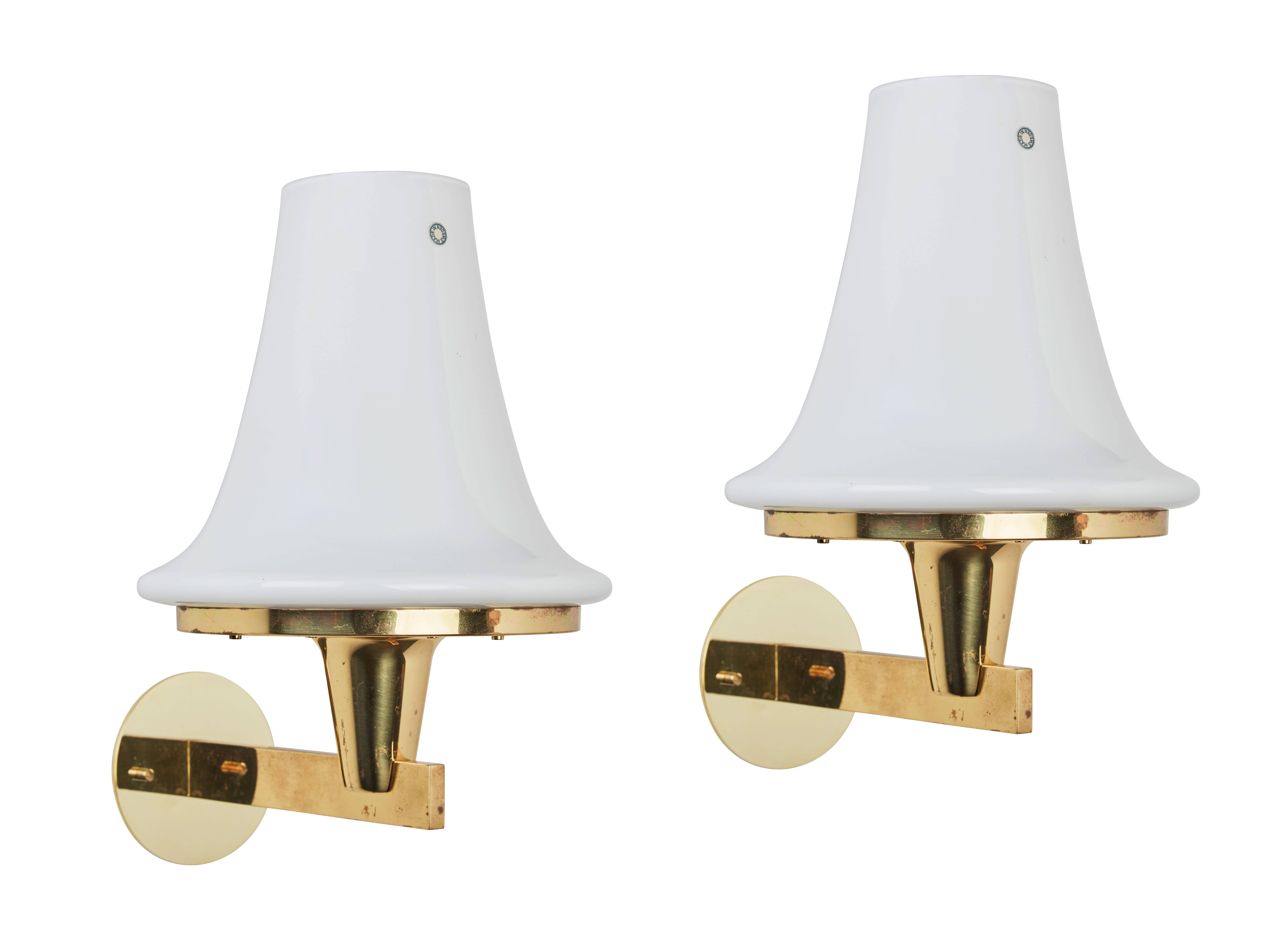 Pair of brass and glass sconces by Hans Agne Jakobsson, Markaryd Sweden, circa 1950s. Wired for US junction boxes. Each sconces takes one E27 75w maximum bulb.