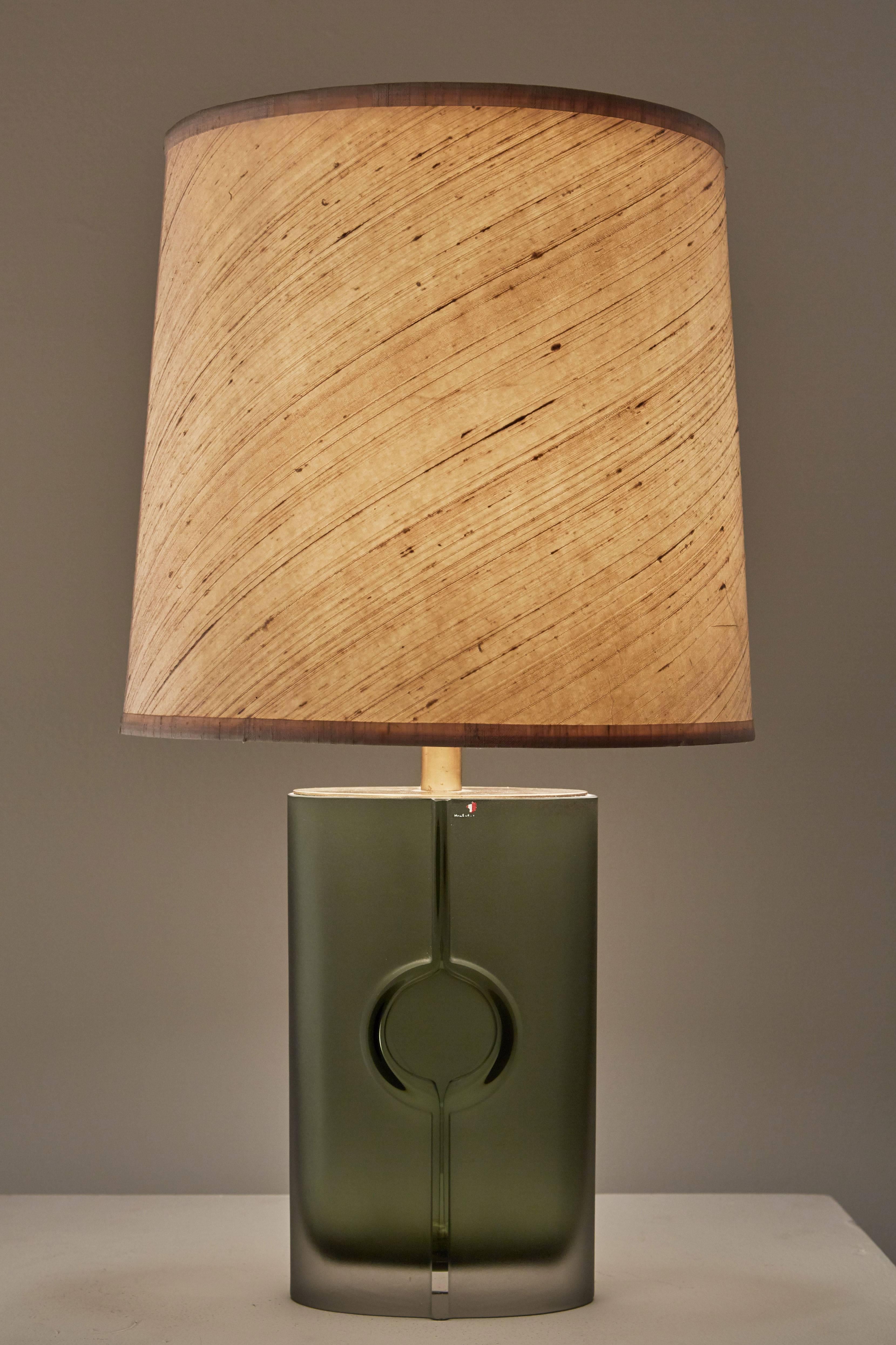 Glass table lamp by Tapio Wirkkala for Iittala in Finland, circa 1950s. Original silk shade, brass hardware. Engraved and numbered 2207 by Tapio Wirkkala. Original cord. Takes one E27 75w maximum bulb. Height displayed includes shade.
  