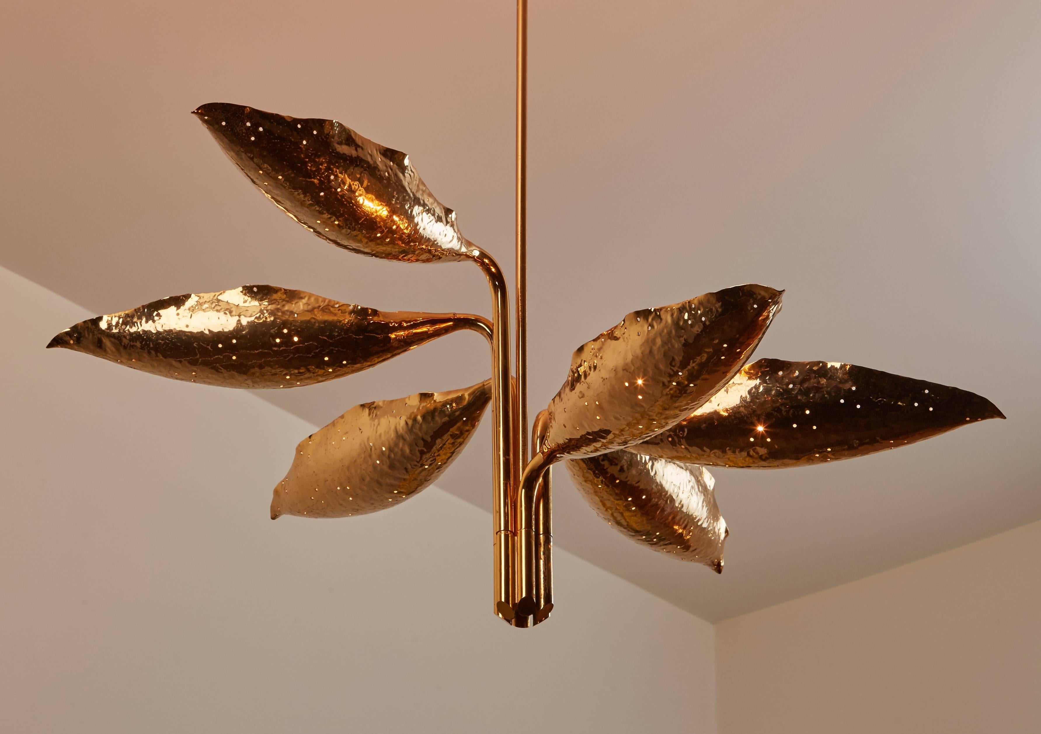 Hand-hammered and perforated brass six-arm chandelier by Angelo Lelli, designed in Italy, circa 1950s. Manufactured by Arredoluce, Monza, Italy. Wired for US junction boxes. Takes six E27 40w maximum bulbs.