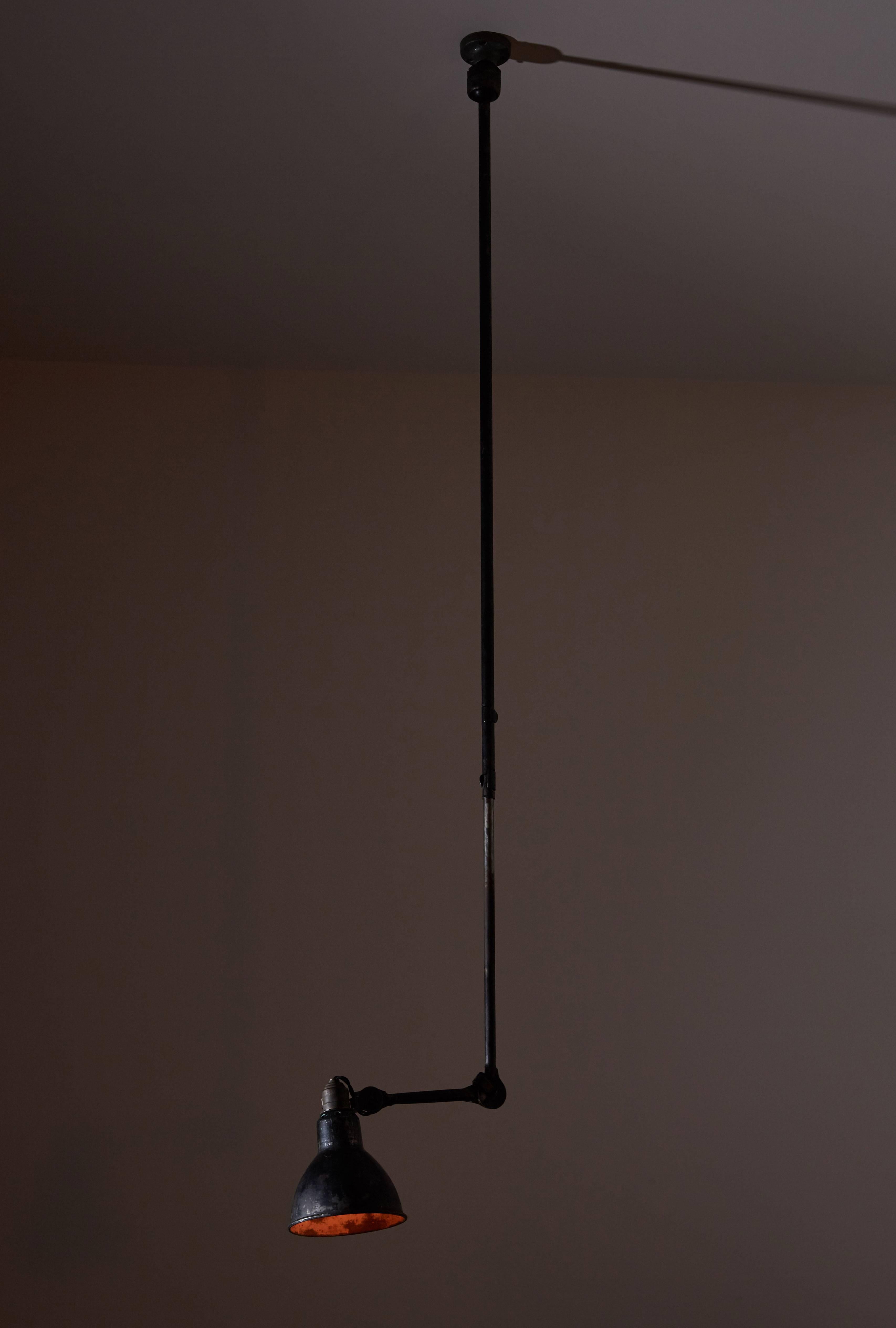 Model No. 302 adjustable ceiling light designed by Bernard Albin Gras for Gras Ravel in France, 1922. Painted steel. Original patina. Shade articulates by use of a ball pivot joint. Rewired for US junction boxes. Takes one 100w maximum bayonet bulb.