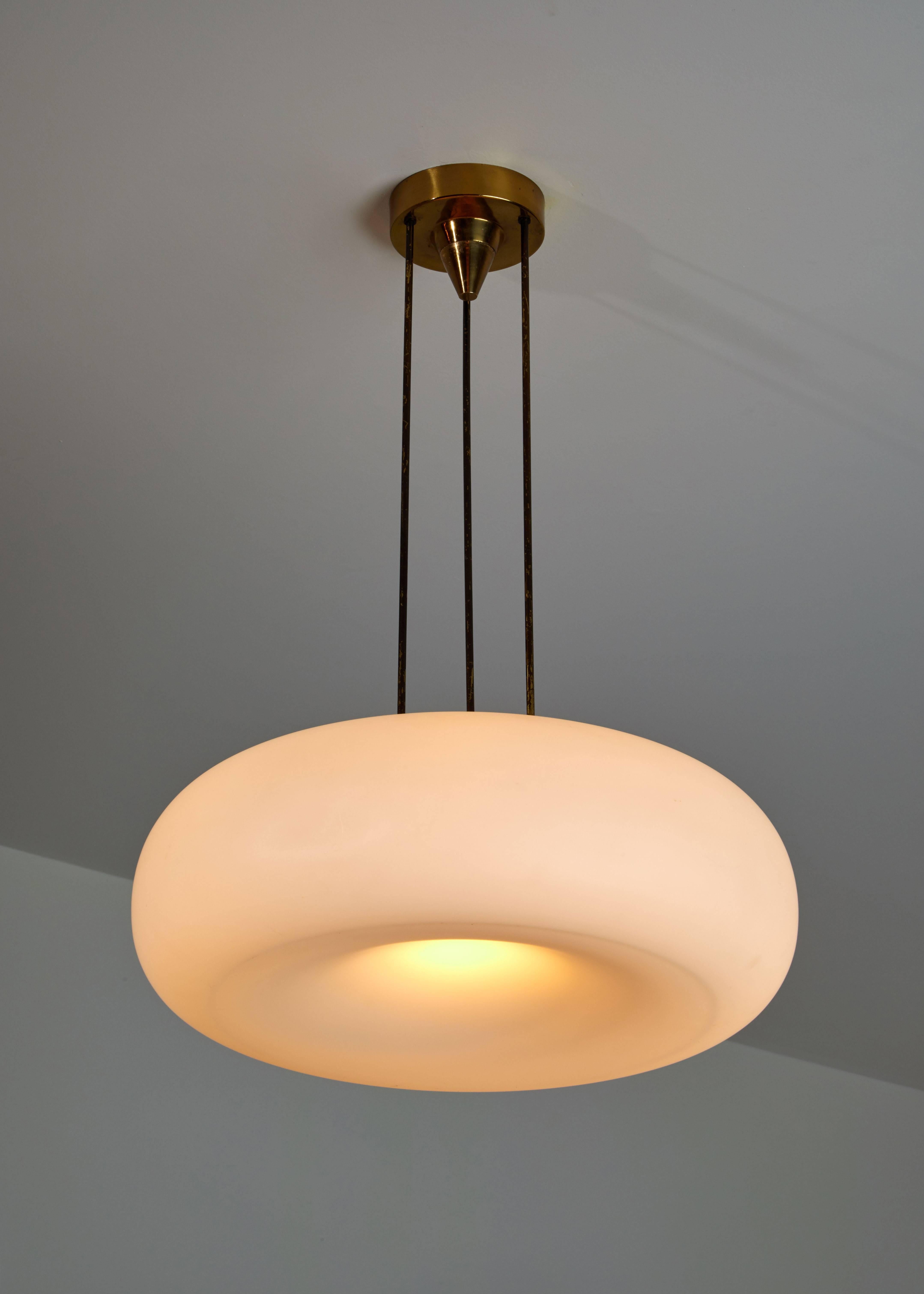 Model 2356 suspension light manufactured by Fontana Arte in Italy, circa 1960s. Original brass canopy, brass hardware, brushed satin opaline glass diffuser. Rewired for US junction boxes. Takes four E12 40w maximum bulbs.