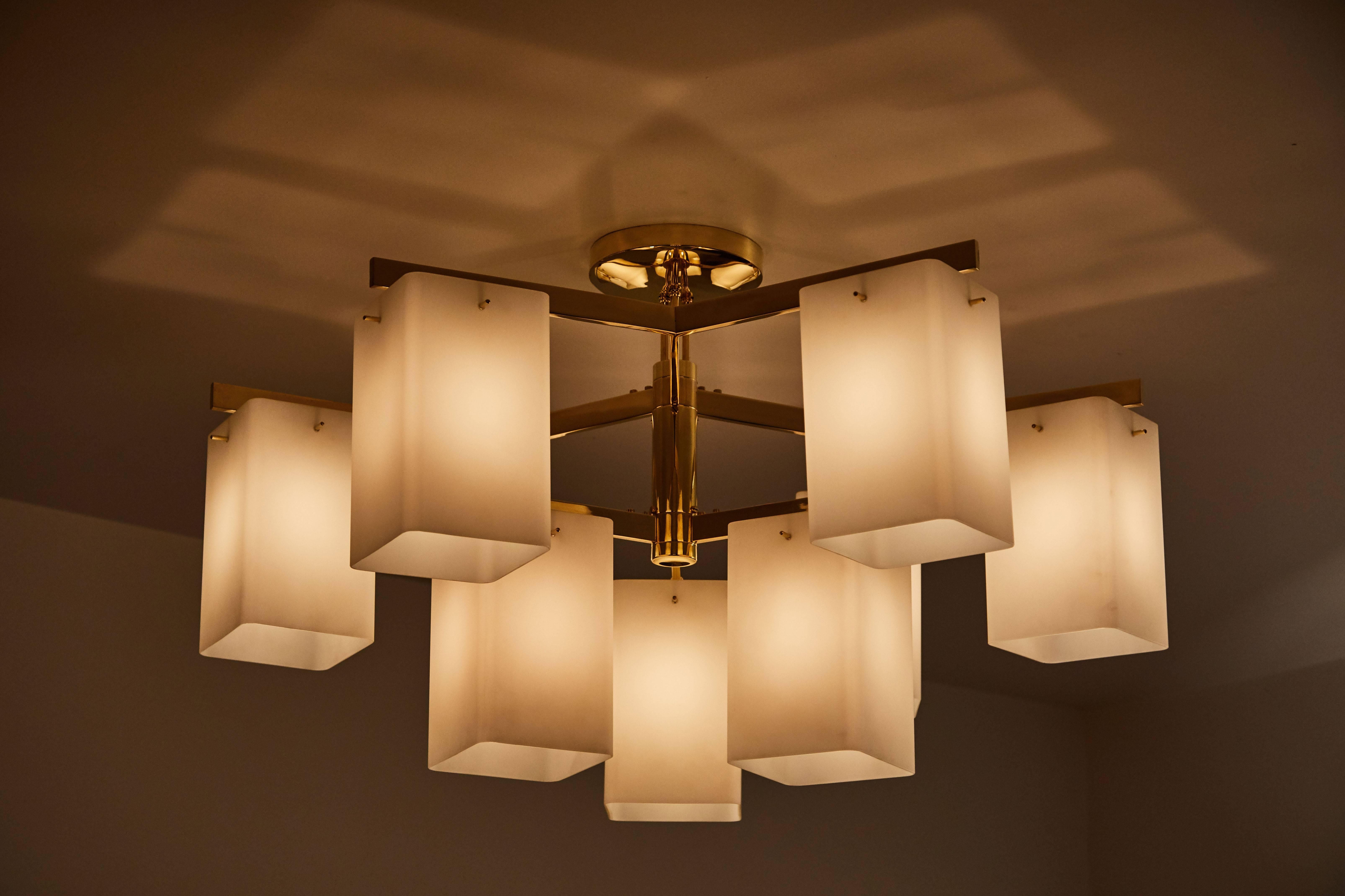 Rare chandelier with nine rectangular brushed satin glass shades and brass plated nickel. Manufactured by Stilnovo in Milan, circa 1960s. Takes nine E27 40w maximum bulbs. Wired for US junction boxes.