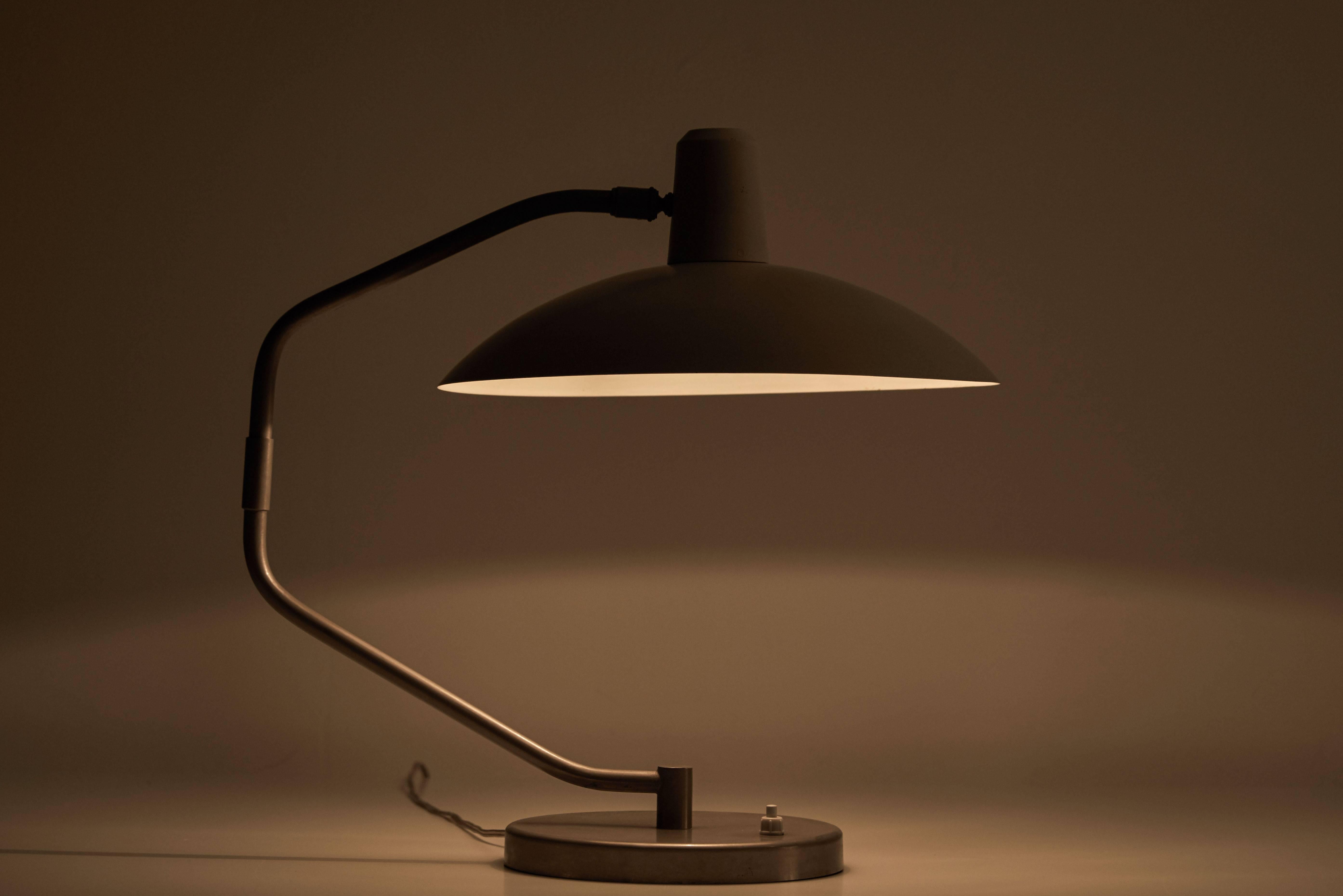 Table Lamp by Clay Michie for Regent Switzerland. Lacquered metal and chromed steel.Articulates and adjust to various positions. Designed in Switzerland circa 1960s. First edition. Original cords. Takes one E27 100w maximum bulb. Change Manufacture