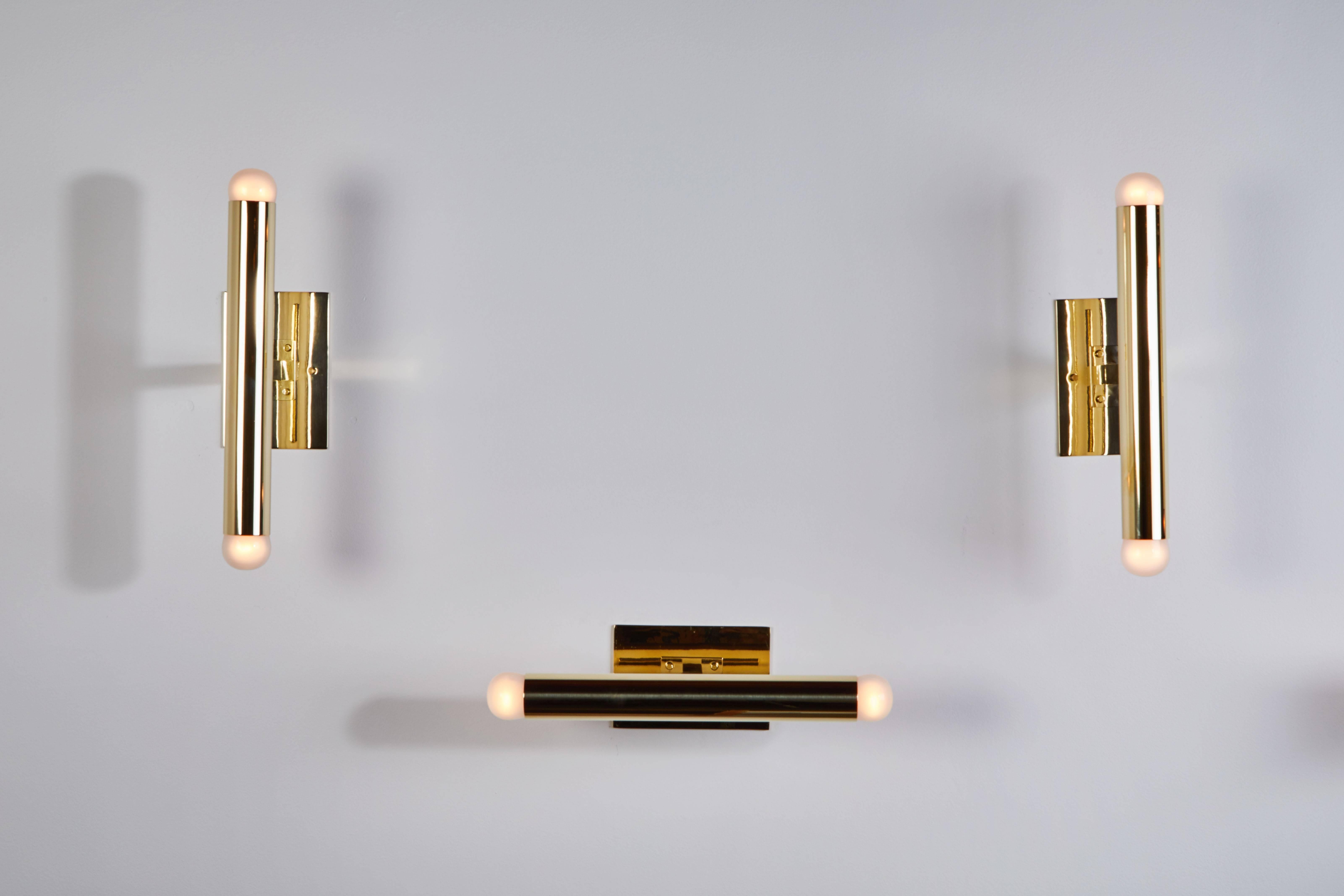 Single brass tubular sconce designed in Italy circa 1960s. Custom backplates, can be mounted horizontally or vertically. Wired for US junction boxes. Each sconce takes two E14 European candelabra. Only one available.