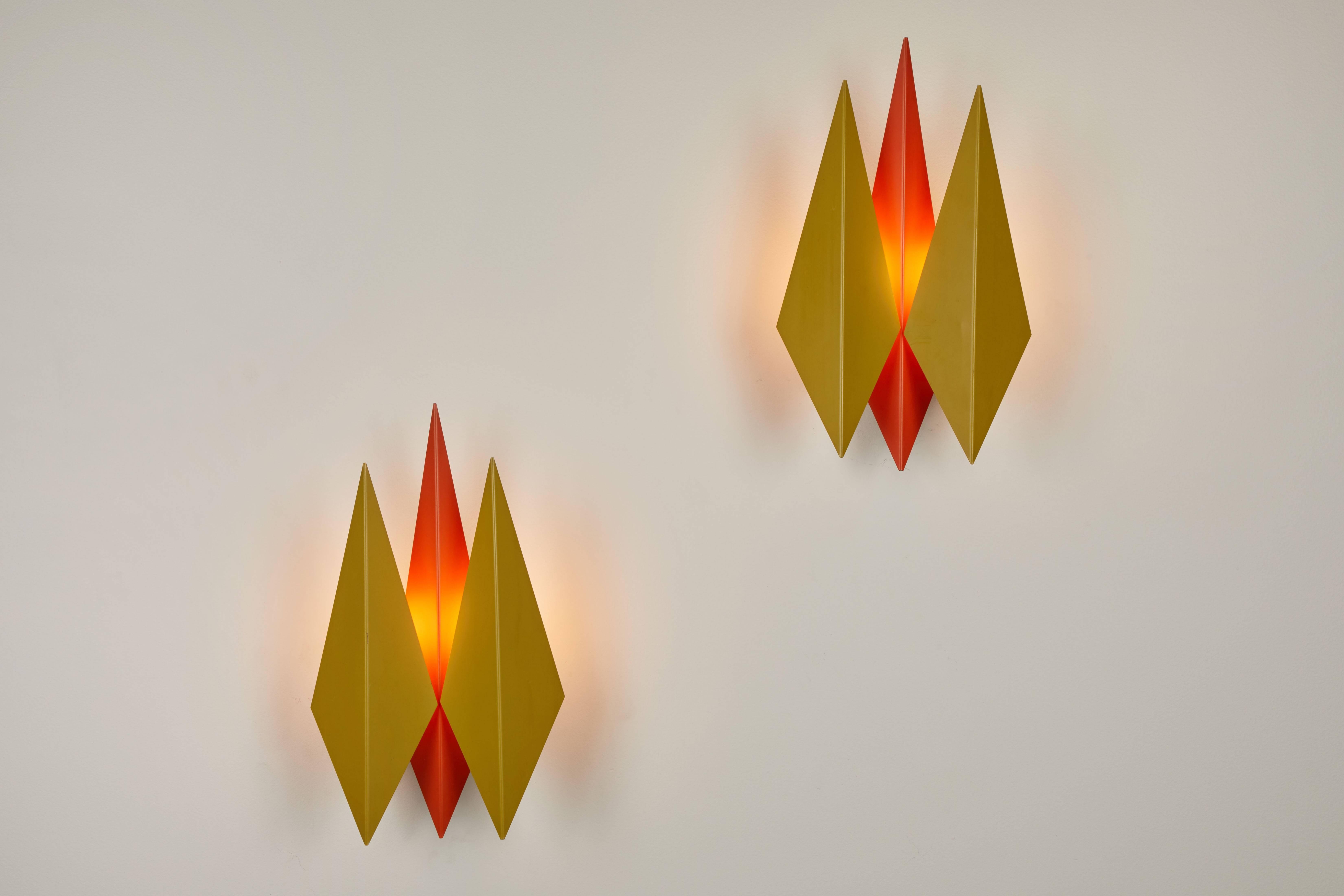 Pair of model 5161 wall sconces designed by Svend Aage Holm Sorensen in Denmark during the 1960s for Holm Sorenson & Co. The sconces feature three folded kite-shaped shades in original painted metal. Wired for US junction boxes, each sconce takes