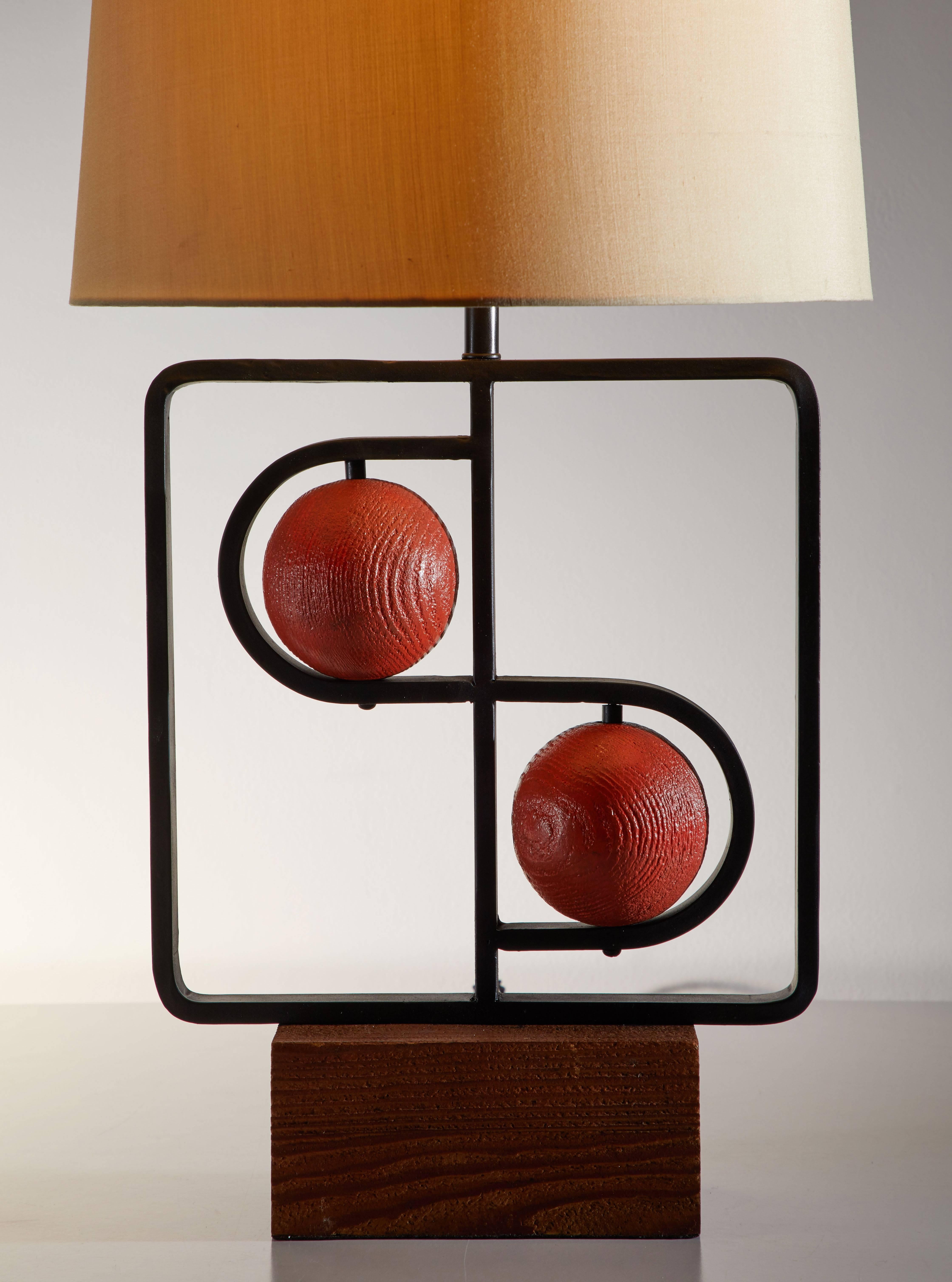 Double D table lamp by Mutual Sunset Lamp Co. designed in the USA, circa 1950s. Iron base with wooden spheres. Shade is for display purposes only. Custom shade fabrication available. Original cord. Takes one E26 75w maximum bulb.