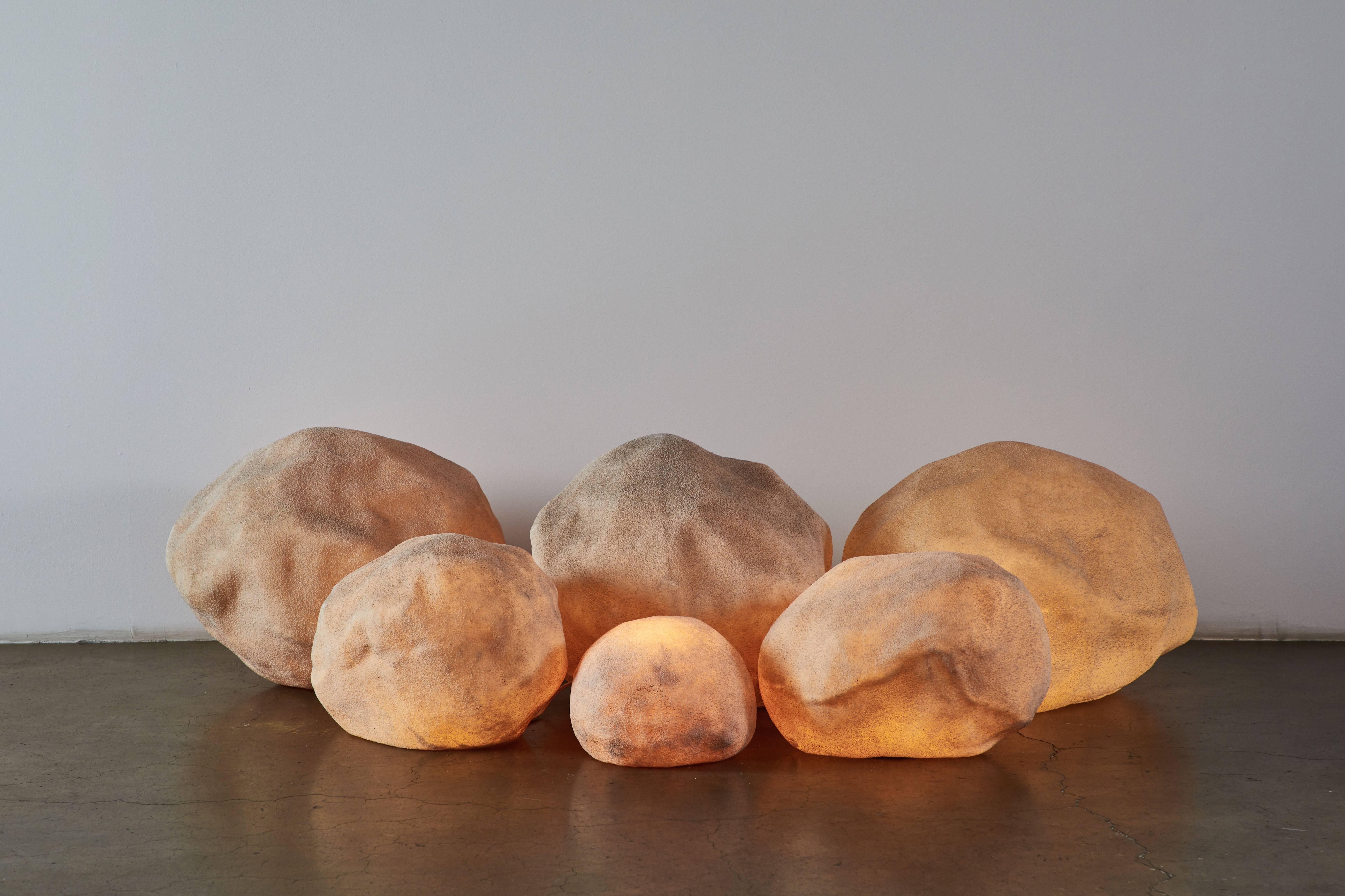 Set of six hand cast fiberglass rocks. Sold in various sizes as a set. The price listed is for the set. Please contact dealer for individual pricing. Original wiring. Each light takes an E27 40w maximum bulb. Dimensions displayed are for largest