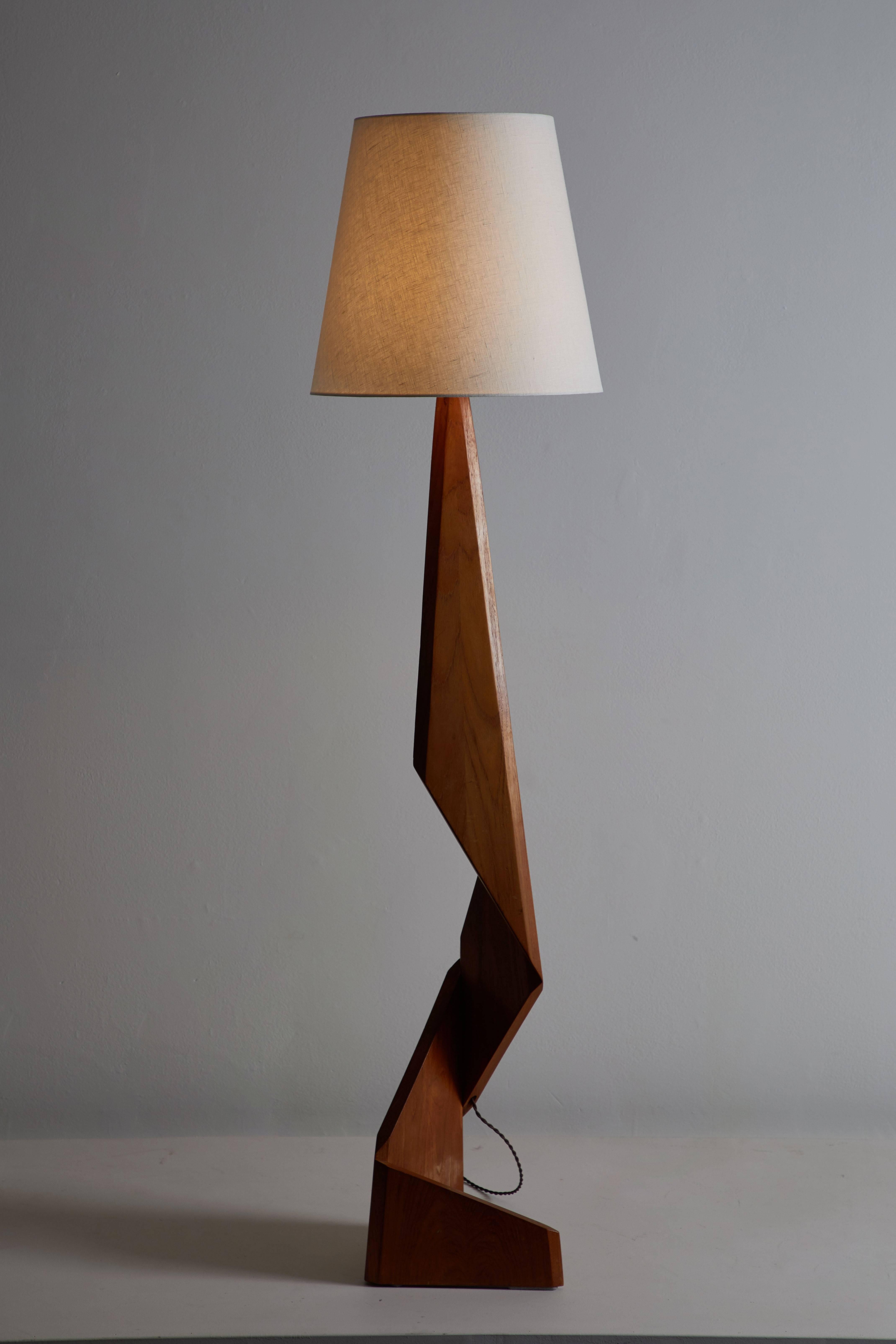 Sculptural floor lamp designed in Denmark, circa 1950s. Rewired with French twist silk cord. Teak base with linen shade. Shade is for display purposes only. Custom shade fabrication available upon request. Takes one E27 100w maximum bulb.
