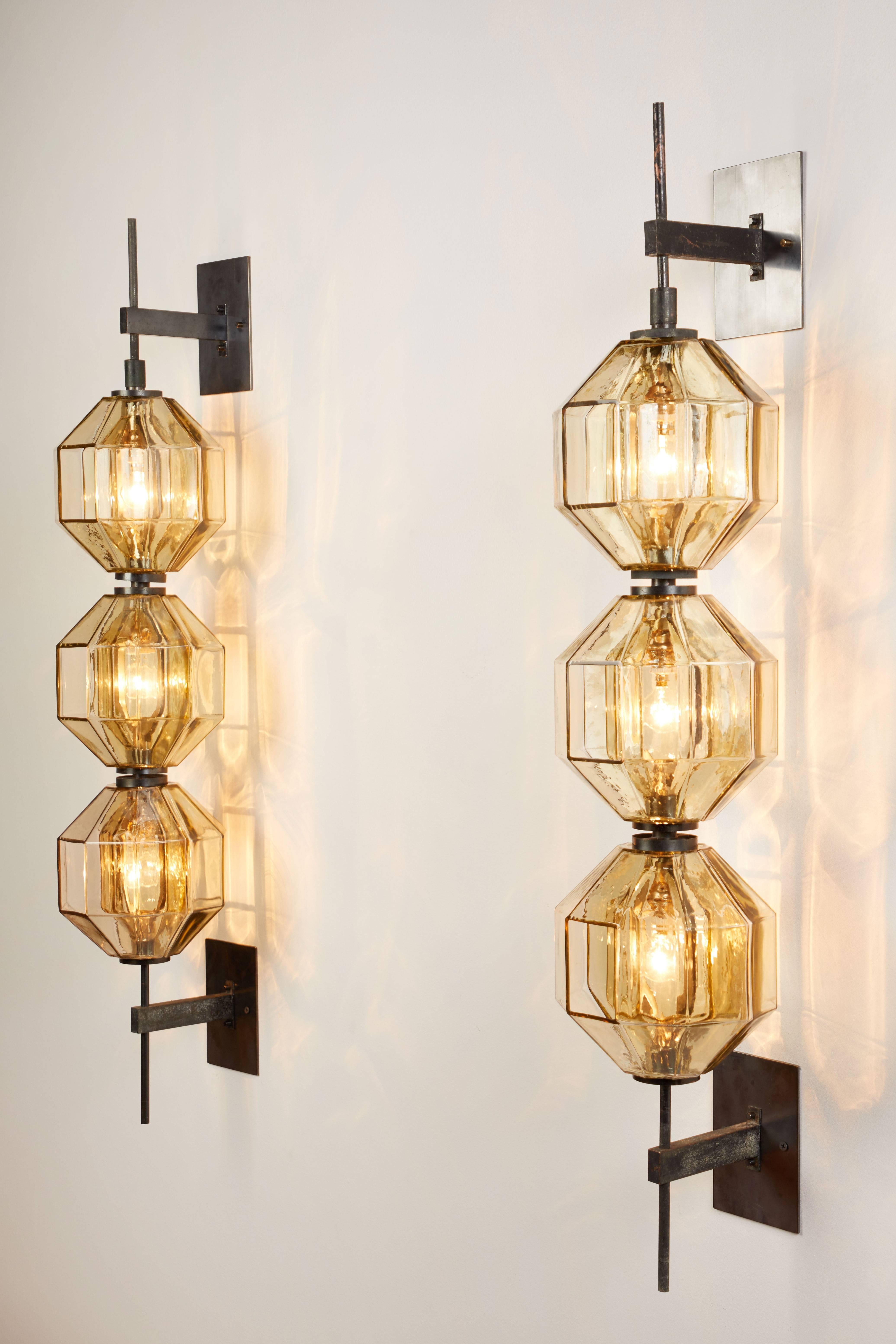 Pair of rare and important wall lights, designed by Vistosi in Italy, circa 1960s. Molded glass with patinated brass hardware. Custom backplates. Rewired for US junction boxes. Each light takes four E14 European candelabra bulbs. Retains original