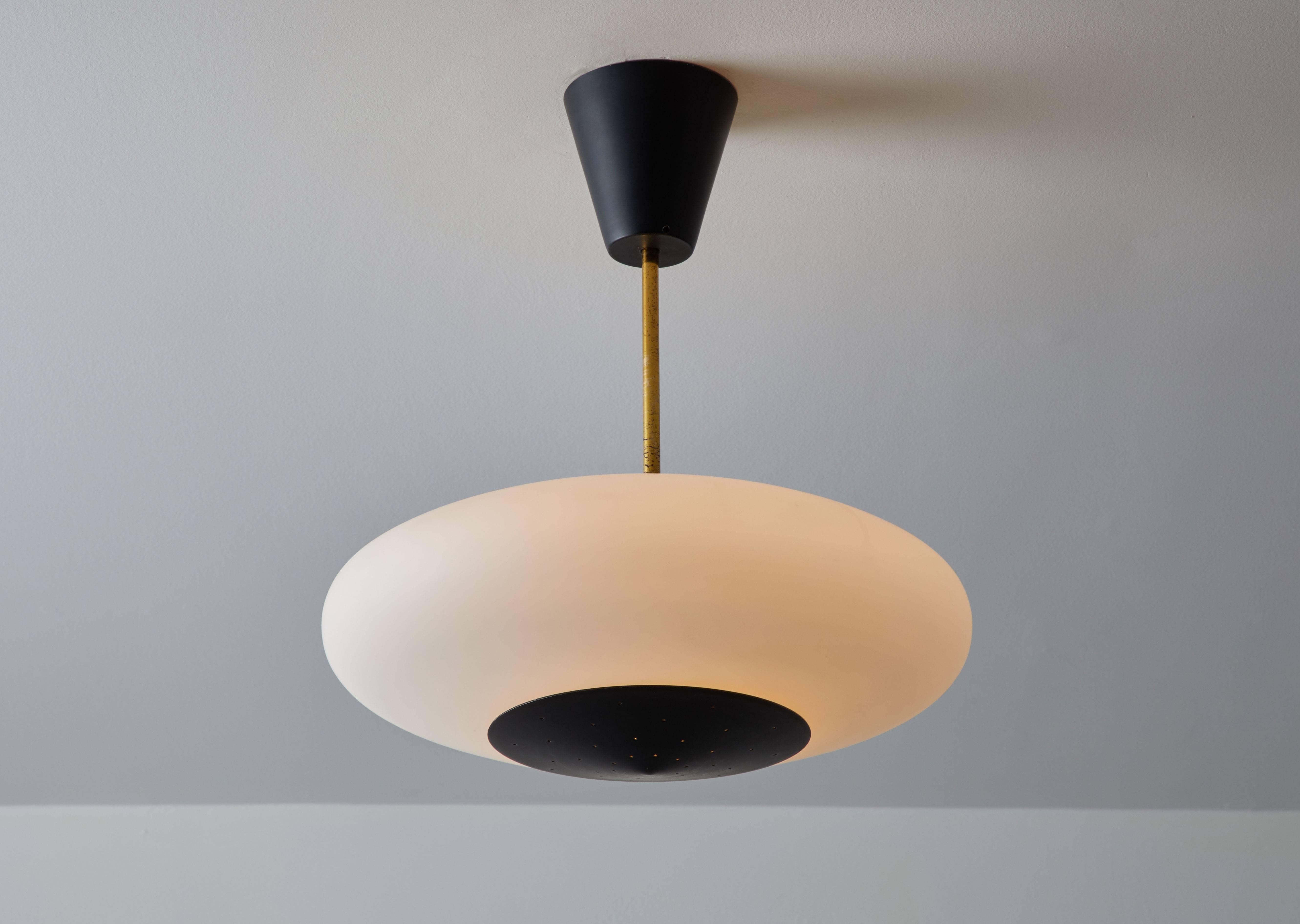 Single flush mount pendant manufactured by Stilux in Italy, circa 1950s. Brushed satin blown glass, brass and metal. Perforated metal detail at bottom of each fixture. Pendants come in three different measurements in length, overall drops can be
