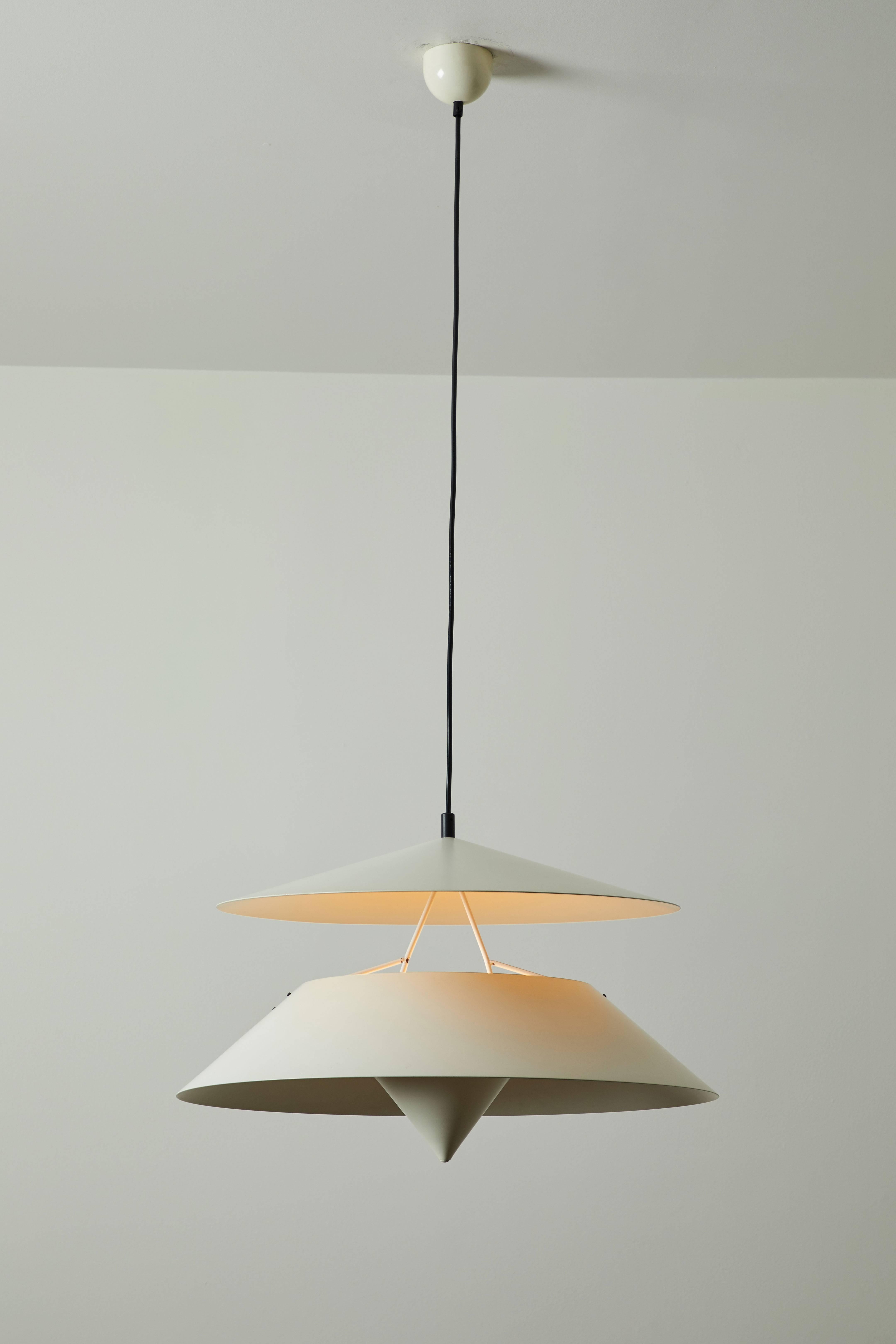 Suspension pendant by Vico Magistretti for Oluce. Designed in Italy, circa 1970s. Painted aluminum and metal. Provides uplight and downlight. Original canopy. Wired for US junction boxes.  Each pendant takes two E27 75w maximum bulbs