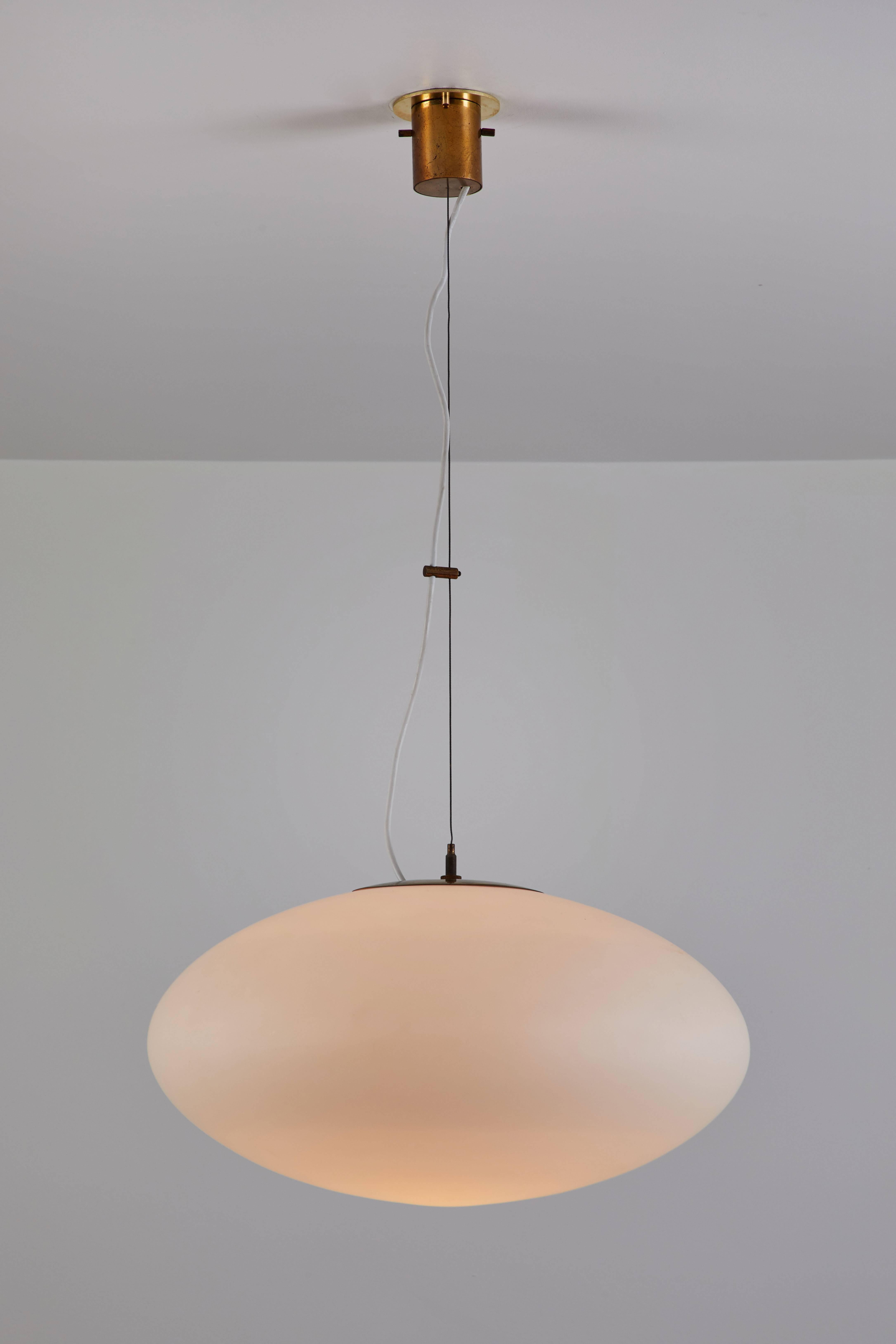Suspension Light by Stilnovo manufactured in Italy, circa 1950s. Brushed satin glass with brass hardware. Custom brass backplates. Rewired for US junction boxes. Overall drop can be customized. Takes one E27 100w maximum bulb.