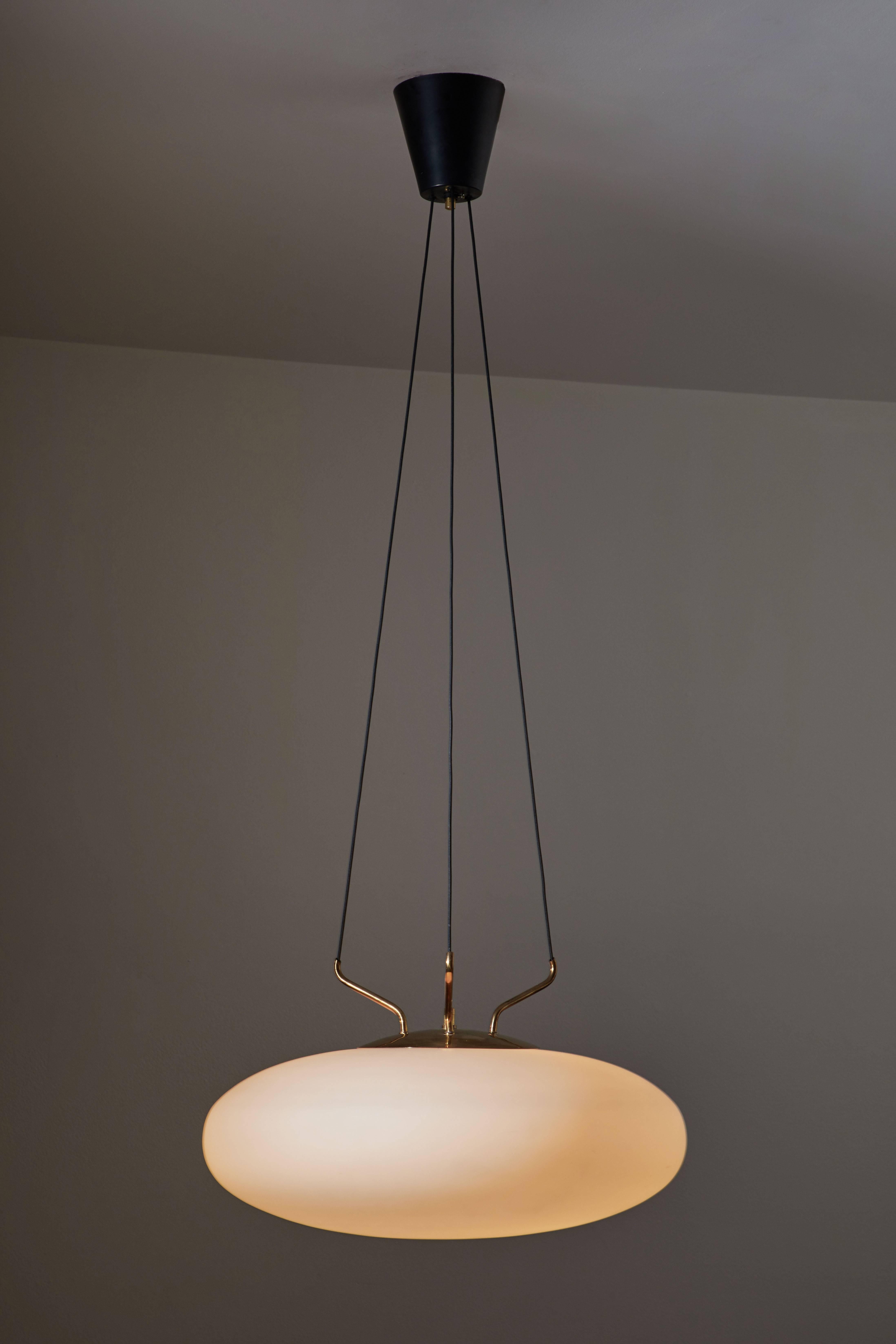 Elliptical shaped pendant manufactured by Stilnovo In Italy, circa 1950s. Brushed satin glass with elegant brass armature that house three suspension wires. Overall drop can be customized. Original canopy. Rewired for US junction boxes. Takes one