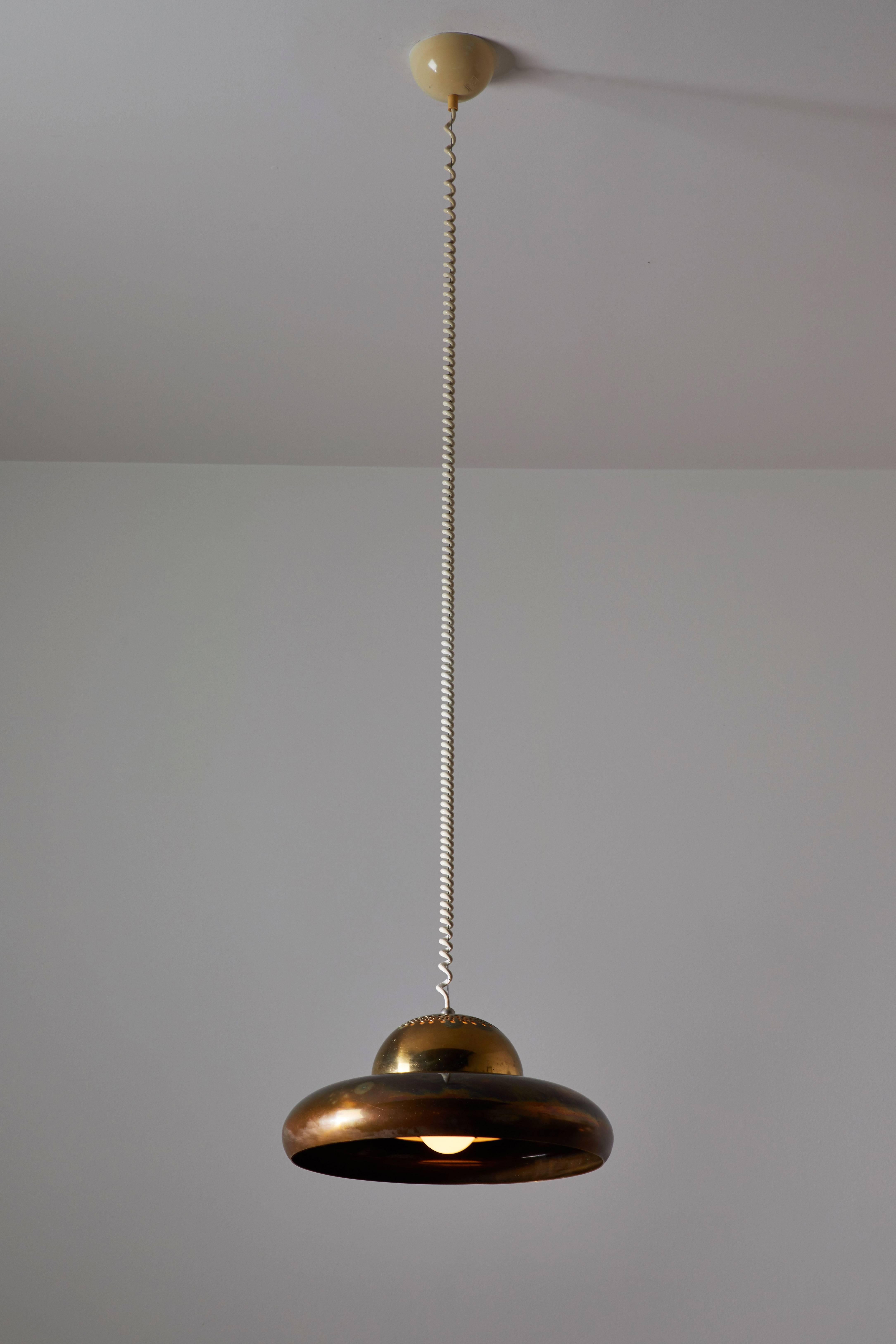 Two Fior di Loto (Lotus Flower) pendant lamps. Designed by Afra & Tobia Scarpa and manufactured by Flos in Italy, 1961. Brass perforated pendants with holophane glass diffusers. No longer in production. Wired for US junction boxes. Four pendants