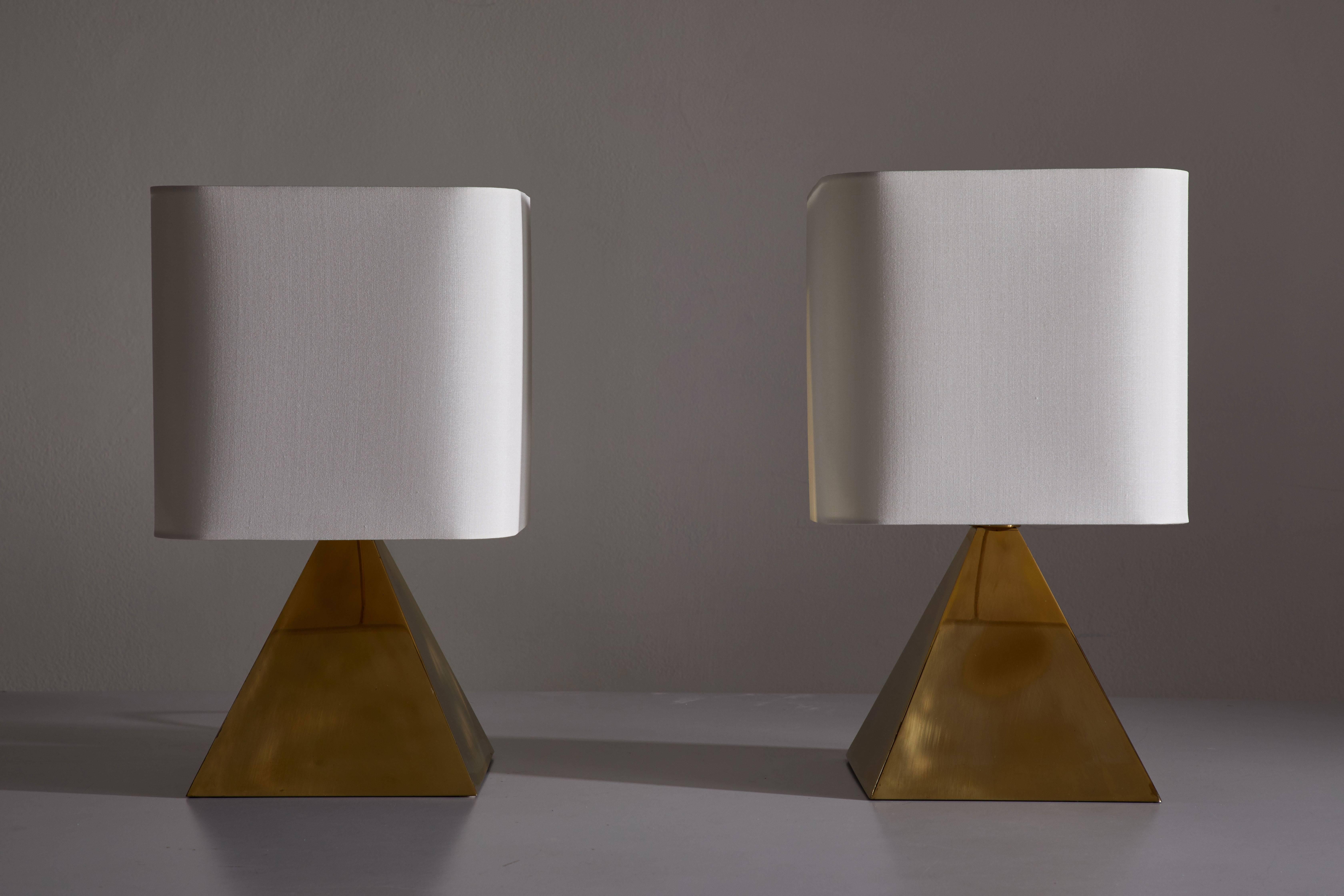 Pair of pyramid shaped hollowed brass table lamps designed in Italy, circa 1970s. Custom fabricated silk shades. Original cords. Each light takes one E27 75w maximum bulb.