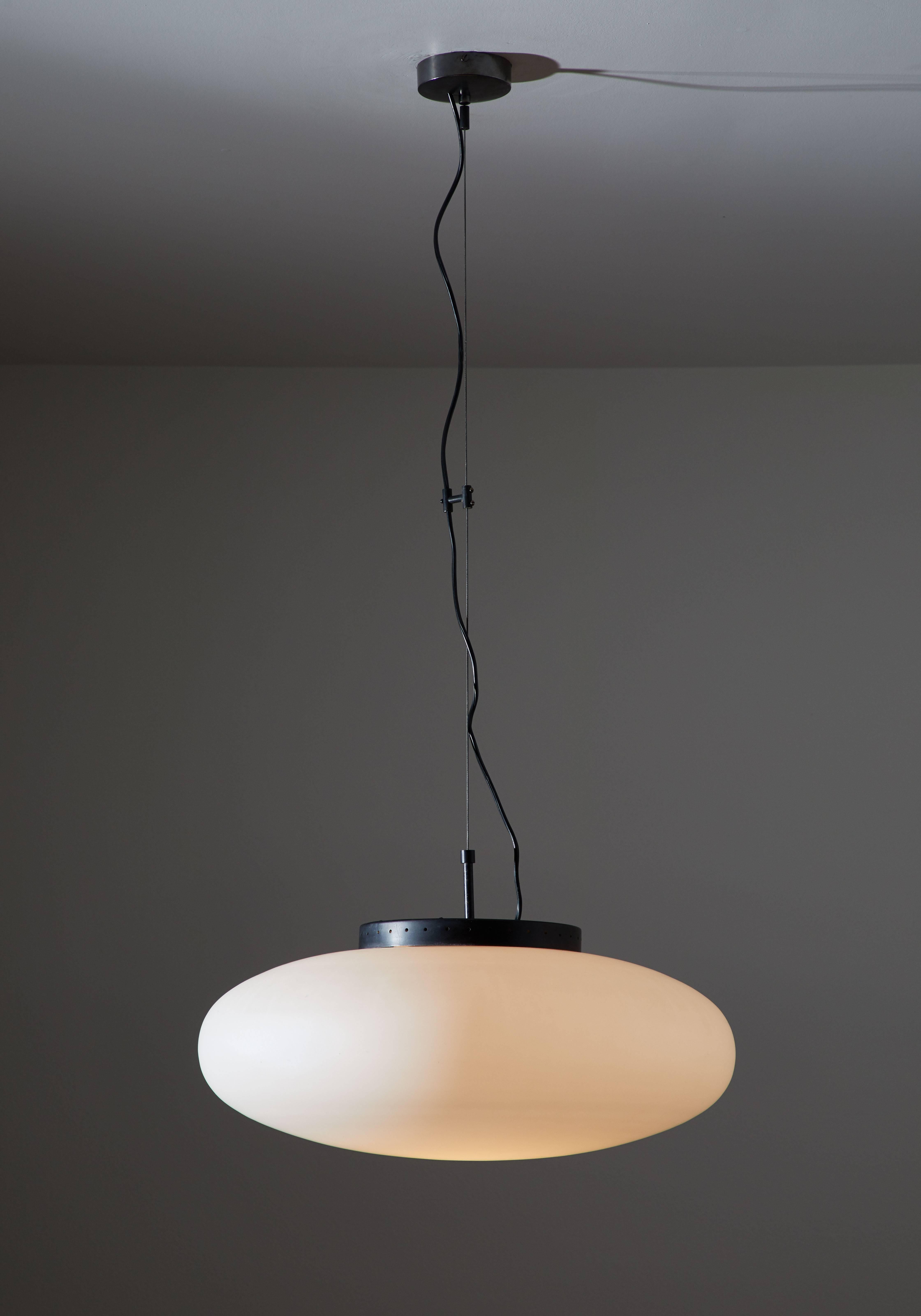 Suspension pendant manufactured in Italy, circa 1950s. Brushed satin glass, enameled metal and brass. Original canopy. Rewired for US junction boxes. Takes one e27 100w maximum bulb. Overall drop can be adjusted.