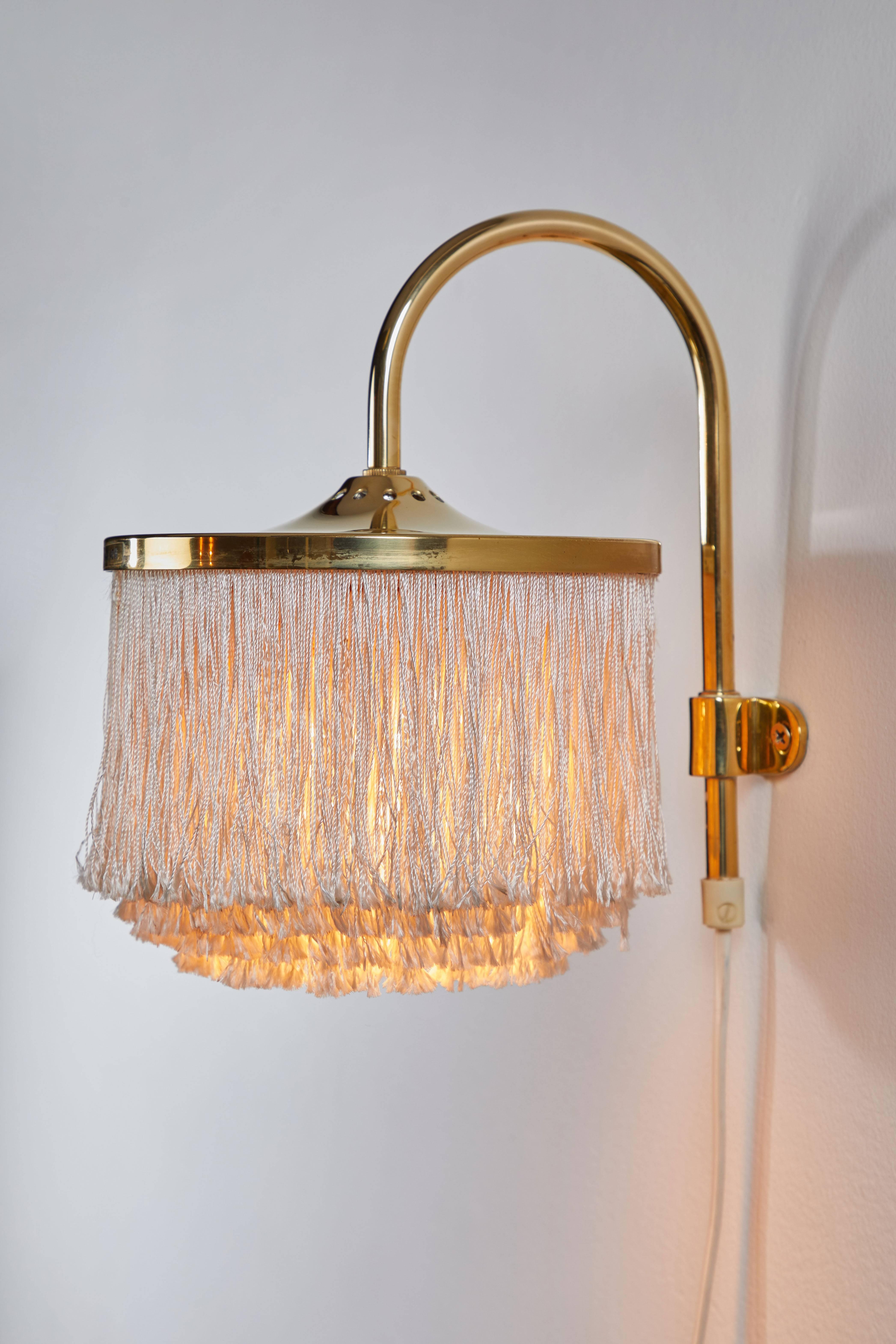 Brass and silk cord fringe wall light by Hans-Agne Jakobsson, Markaryd. Designed in Sweden, circa 1950s. Original cord and plug. Takes one E27 60w maximum bulb.