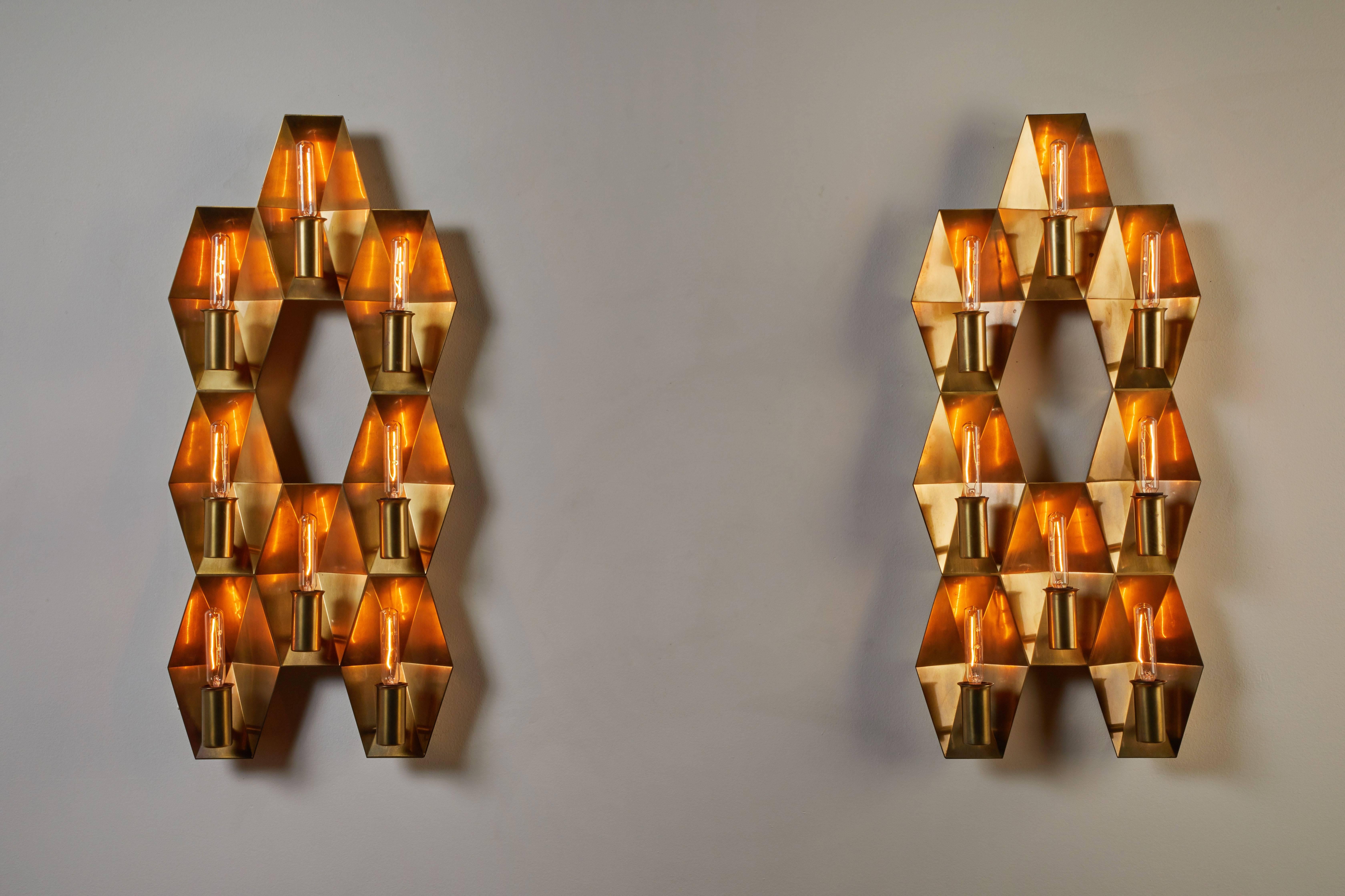 Two brass wall lamps manufactured by Fog & Mørup in Denmark, circa 1960s. Brass with eight sockets per light. Wired for US junction boxes, each light takes one E14 25w maximum bulb. Priced and sold individually. Provenance: St. Johannes Kirke,