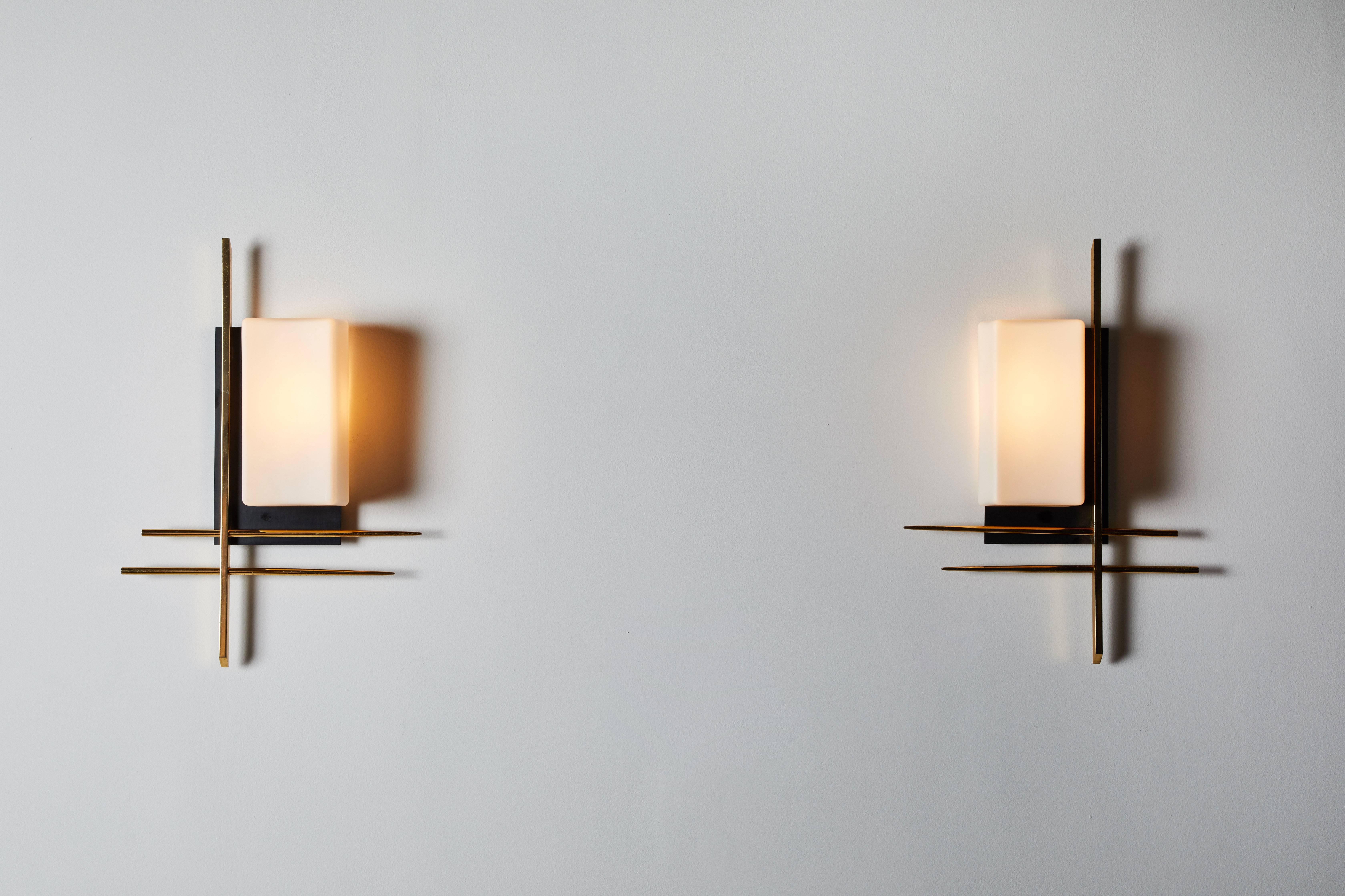 Pair of sconces by Arlus manufactured in France, circa 1950s. Brass, enameled metal and brushed satin glass. Wired for US junction boxes. Each sconce takes one 75w maximum Bayonet bulb.